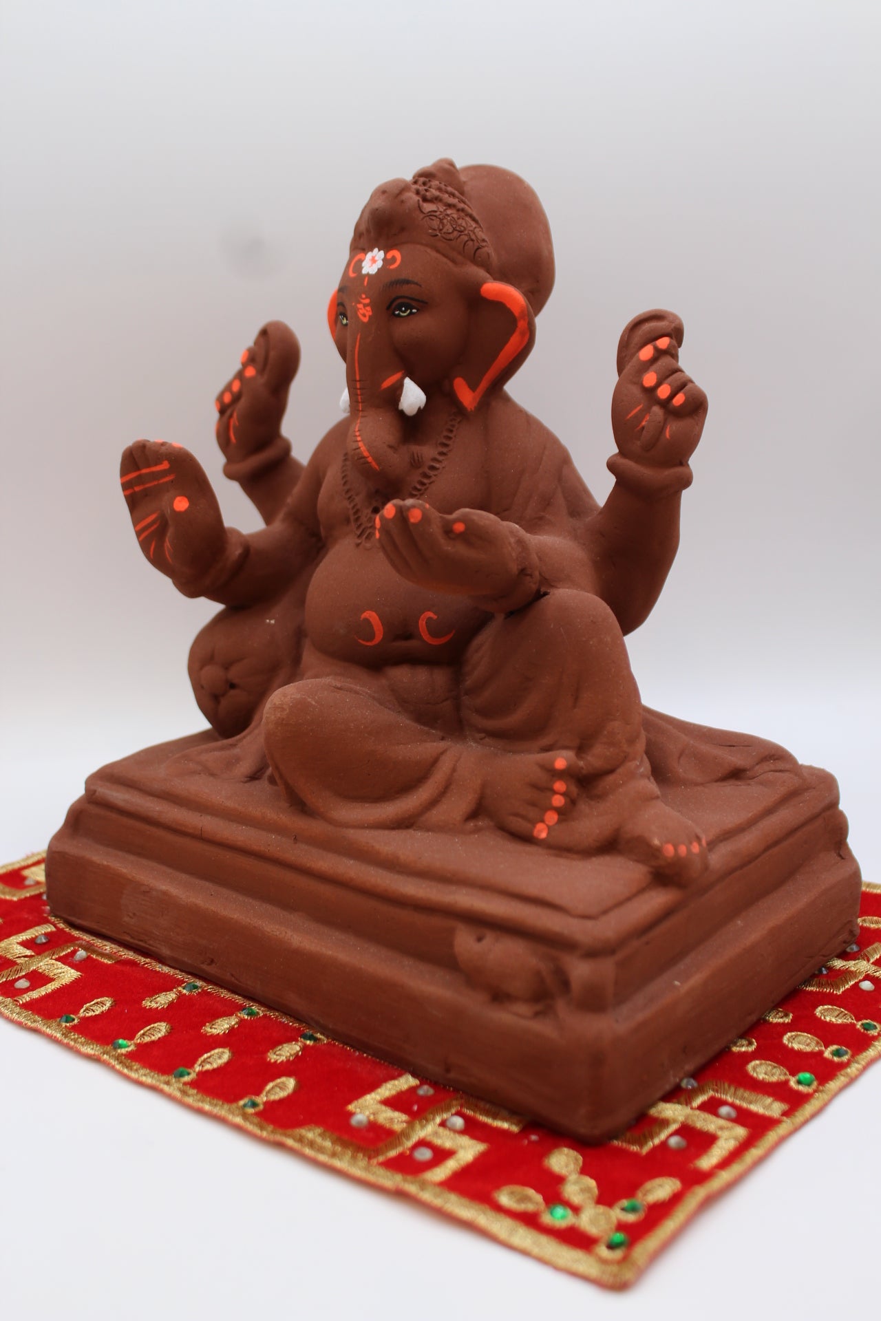 Natural terracotta eco-friendly 8 inch Ganesh Visarjan idol in relaxed pose – detail view