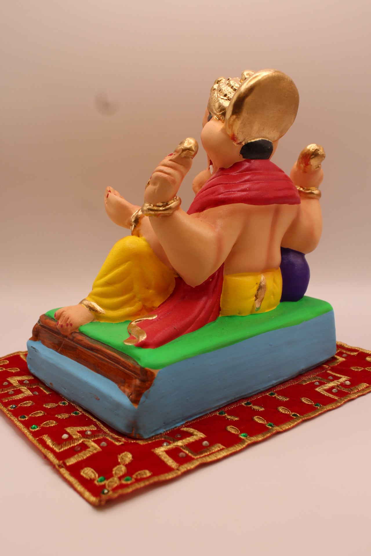 Eco-friendly 8 inch Ganesh Visarjan idol in rose shawl and yellow dhoti – back view