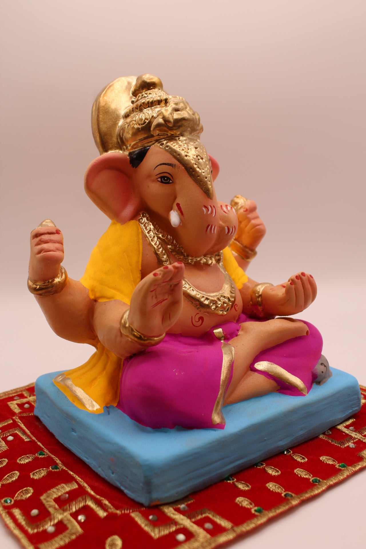 Eco-friendly 8 inch Ganesh Visarjan idol in yellow shawl and magenta dhoti – side view