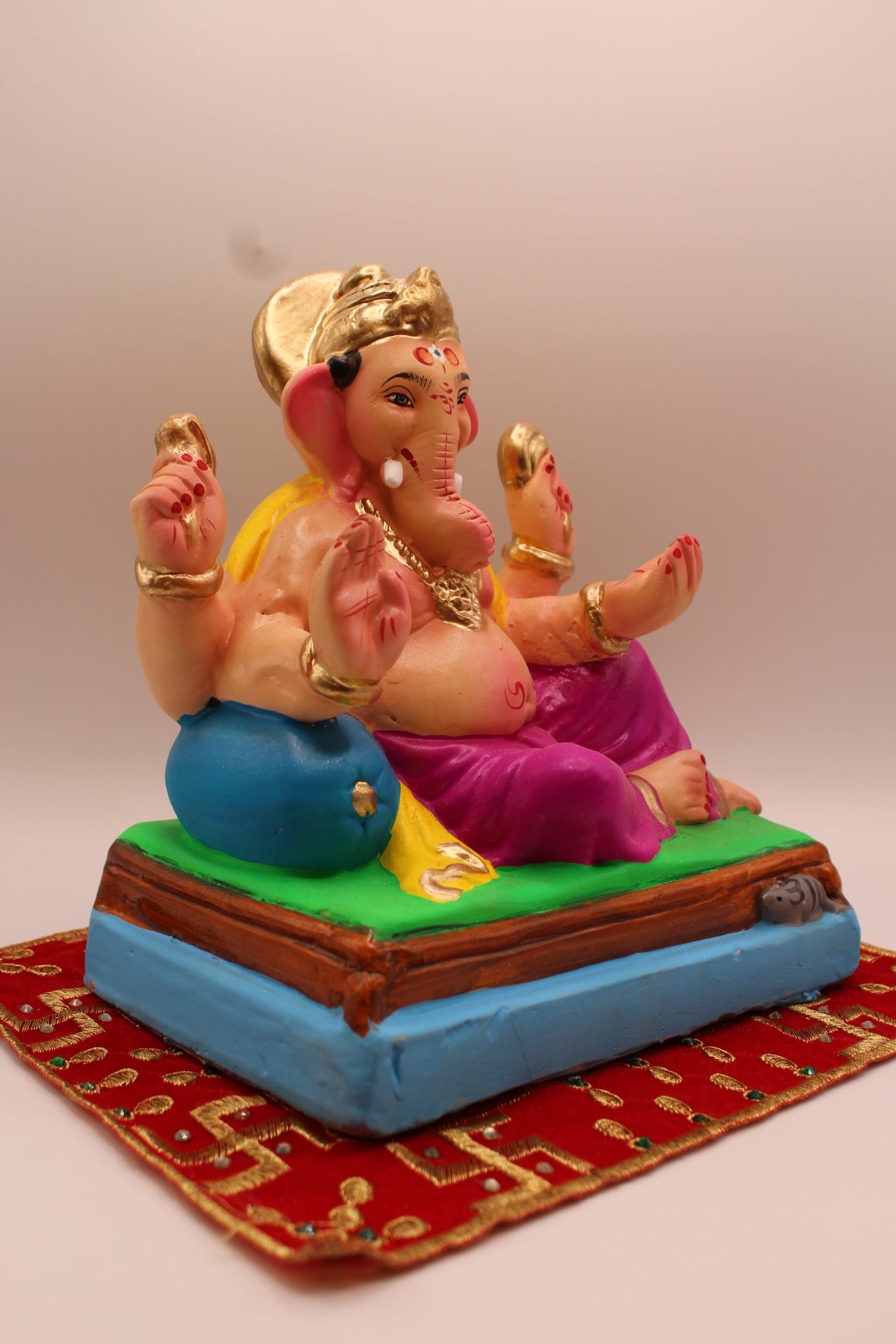Eco-friendly 8 inch Ganesh Visarjan idol in yellow shawl and magenta dhoti – side view