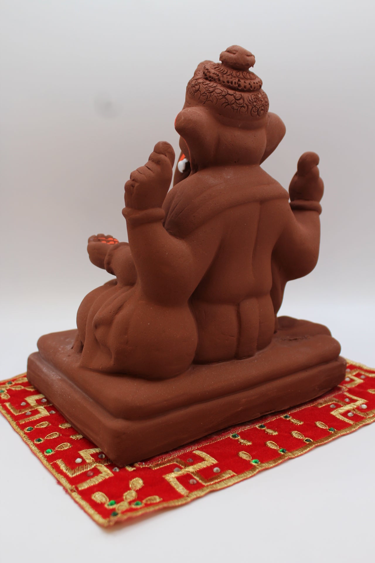 Natural terracotta eco-friendly 8 inch Ganesh Visarjan idol with topknot – back view