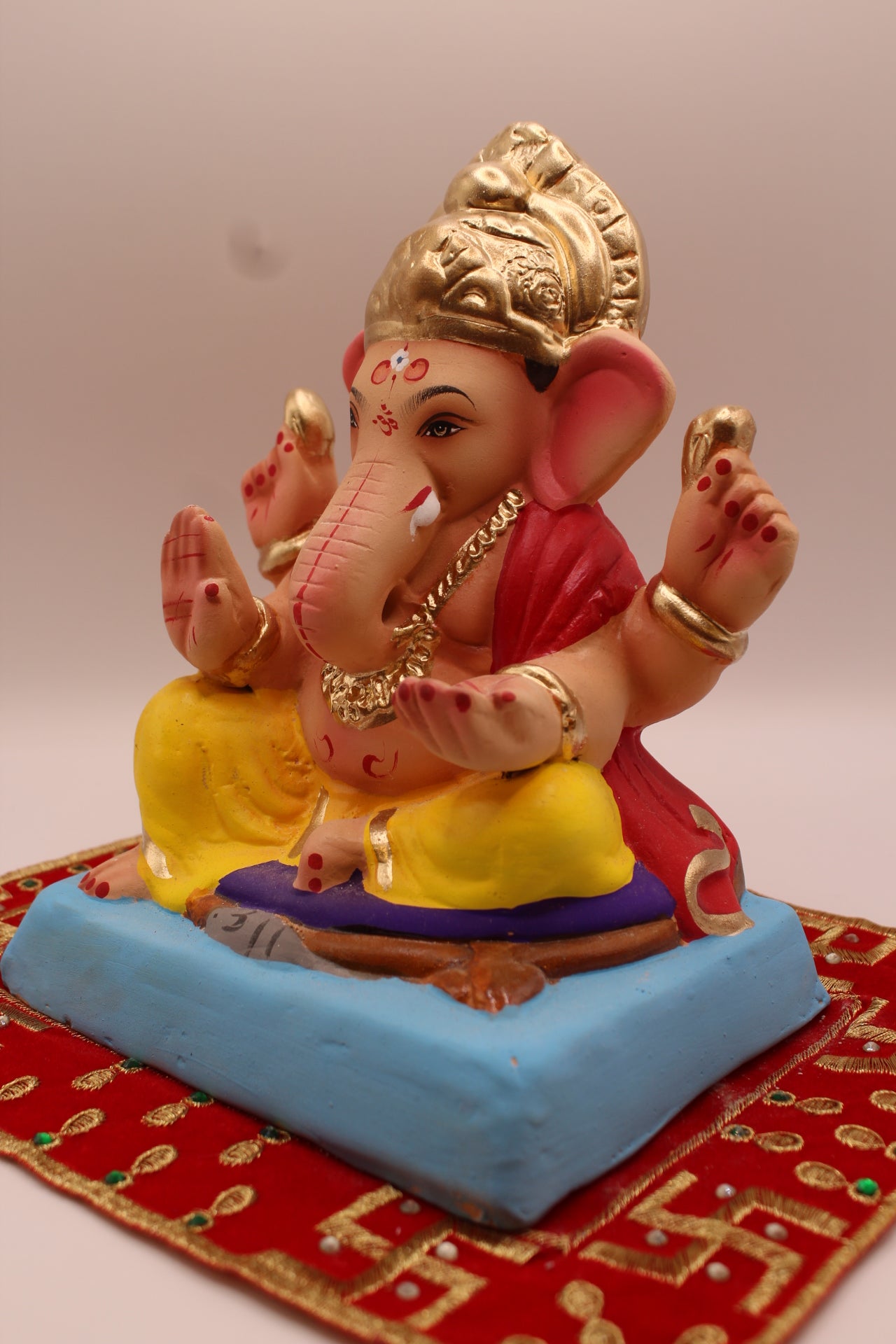 Eco-friendly 8 inch Ganesh Visarjan idol in red blouse and yellow dhoti – detail view