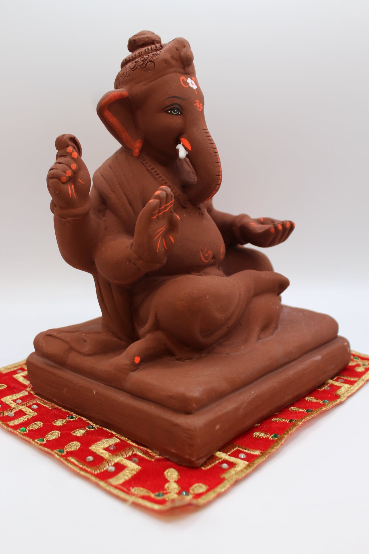 Natural terracotta eco-friendly 8 inch Ganesh Visarjan idol with topknot – side view