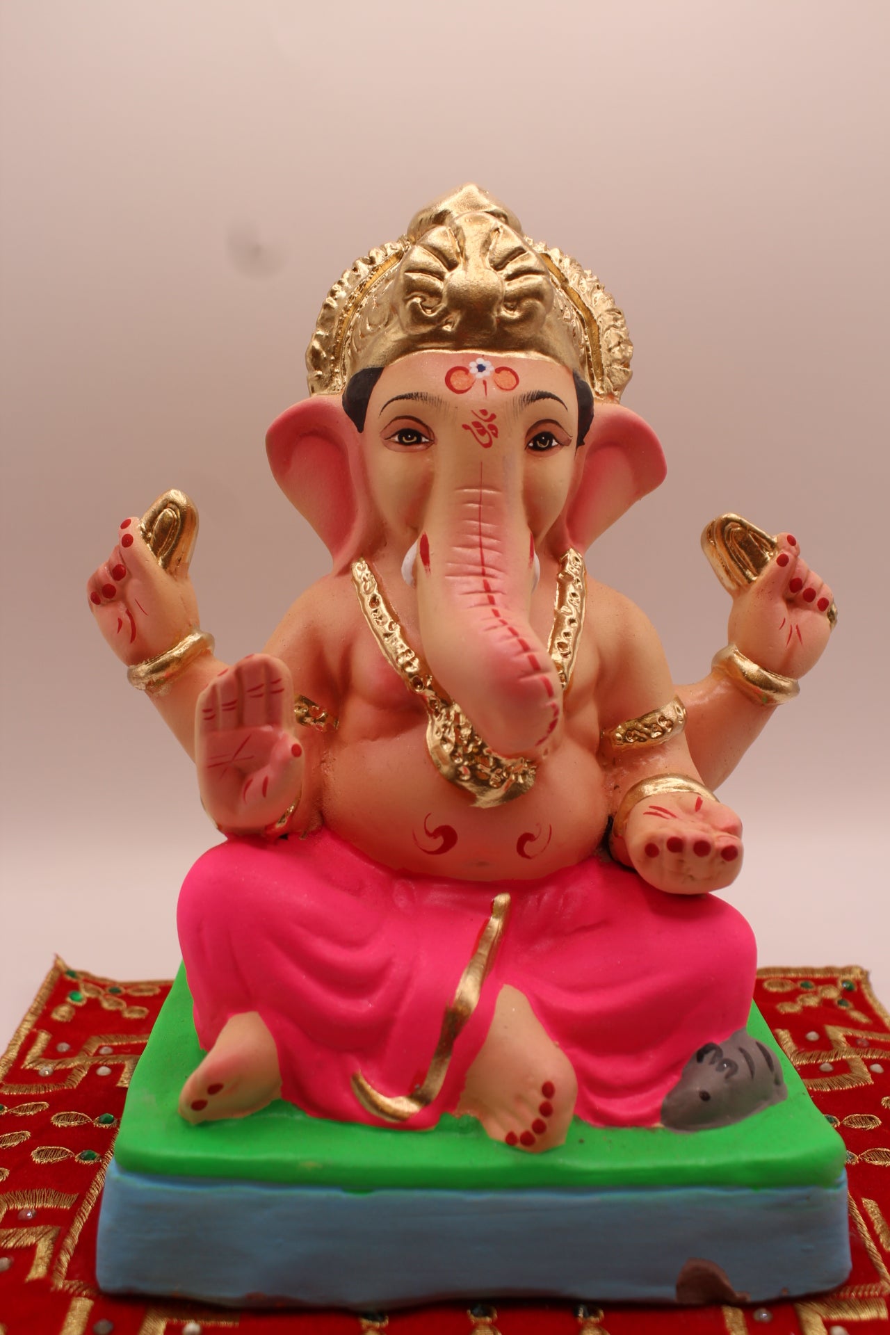 Eco-friendly 8 inch Ganesh Visarjan idol with gold fan crown and rani pink dhoti – front view