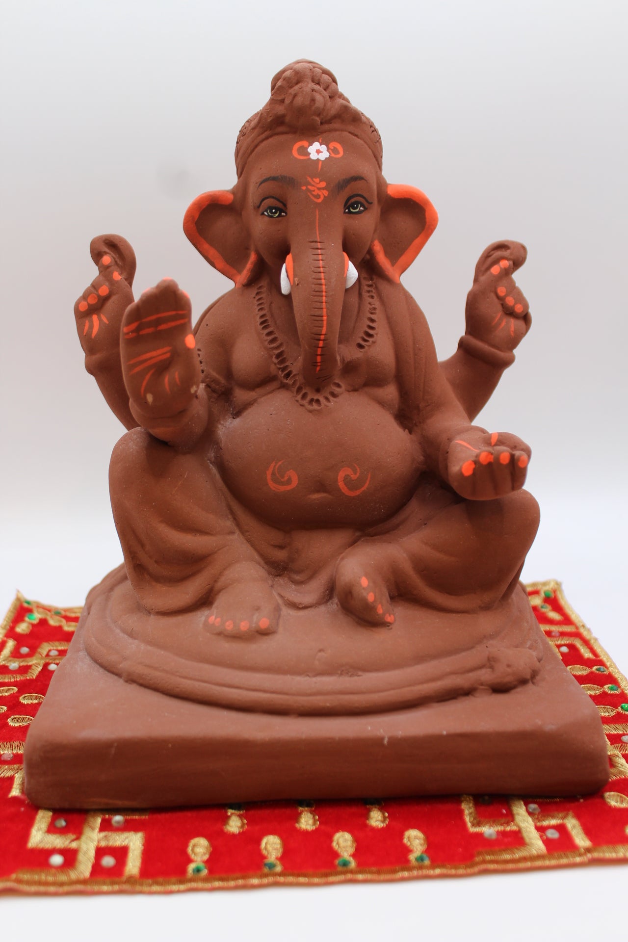 Natural terracotta eco-friendly 8 inch Ganesh Visarjan idol with bun topknot – front view