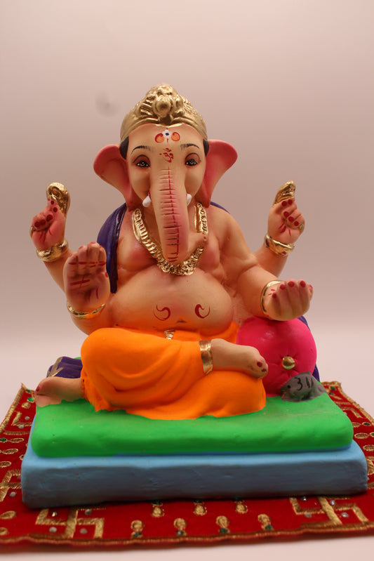 Eco-friendly 8 inch Ganesh Visarjan idol in purple shawl and orange dhoti with pink bolster – front view