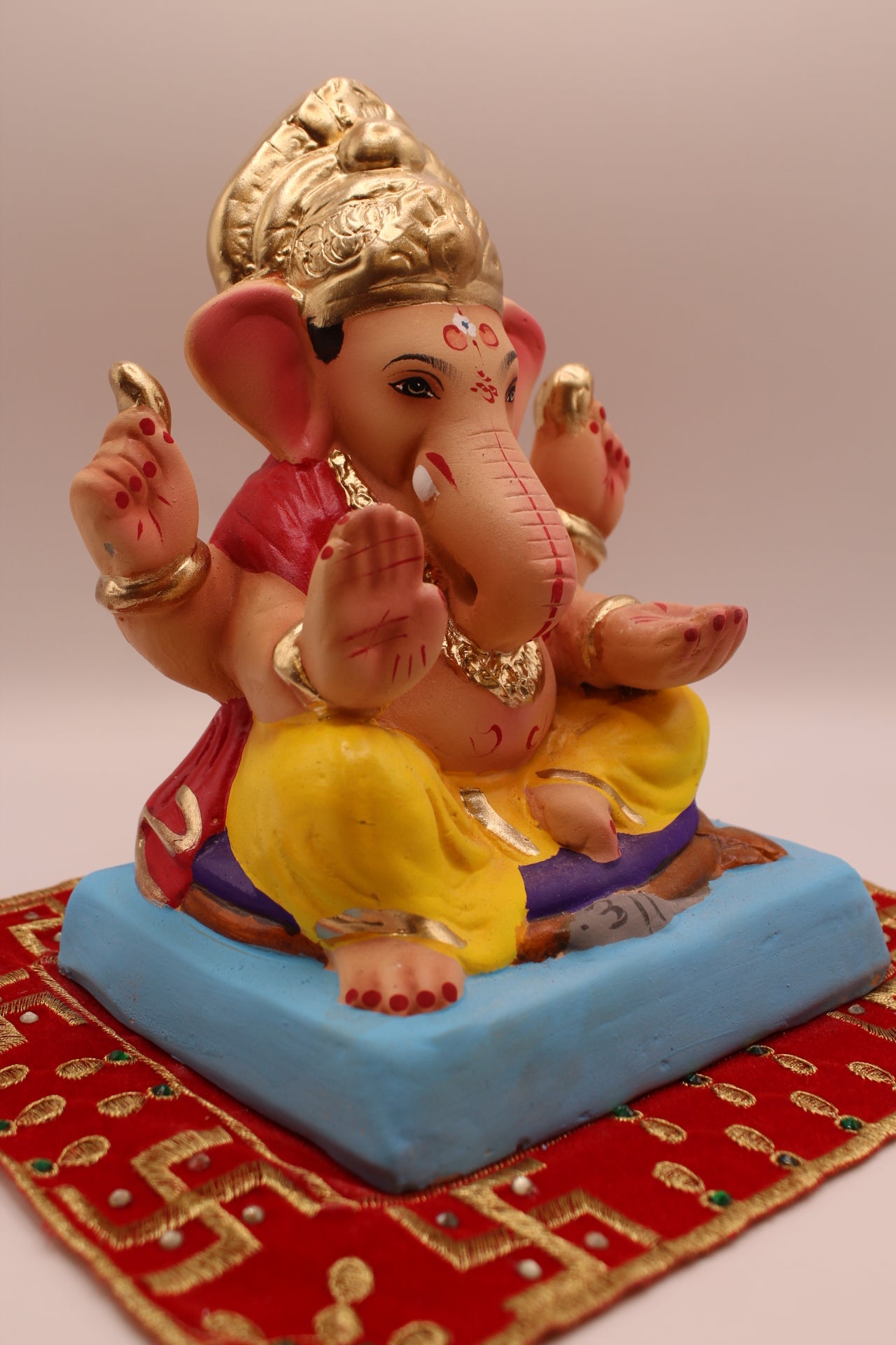Eco-friendly 8 inch Ganesh Visarjan idol in red blouse and yellow dhoti – side view
