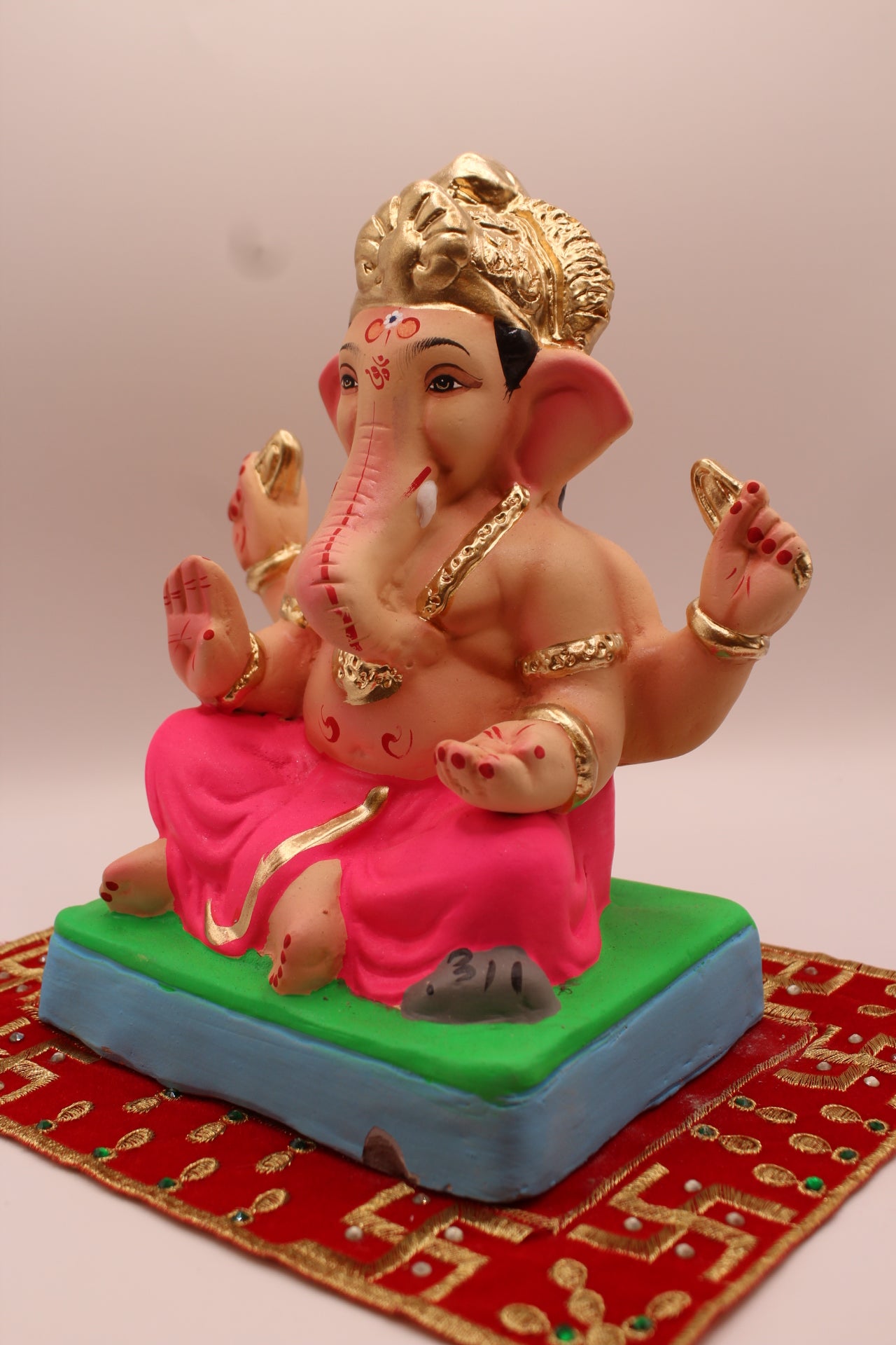 Eco-friendly 8 inch Ganesh Visarjan idol with gold fan crown and rani pink dhoti – detail view