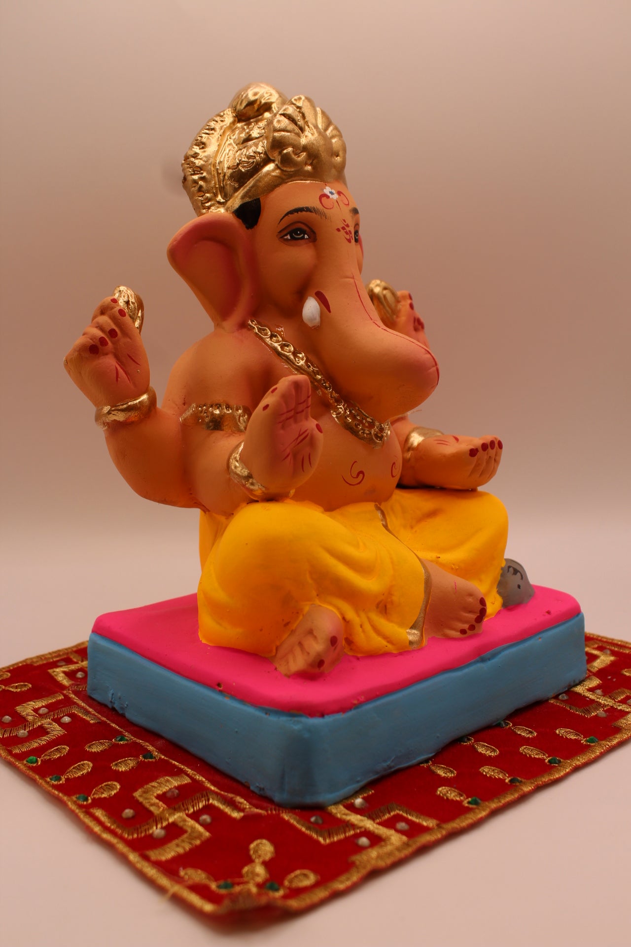 Eco-friendly 8 inch Ganesh Visarjan idol with yellow dhoti and gold fan crown – side view