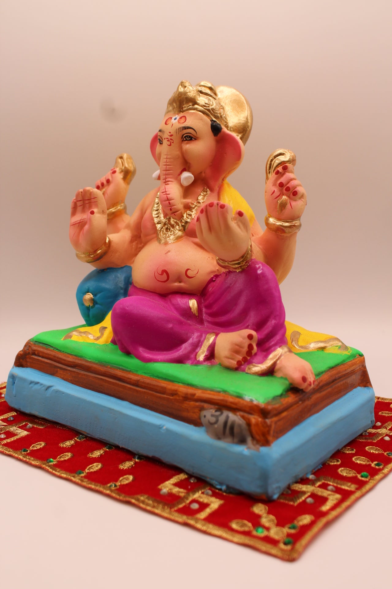 Eco-friendly 8 inch Ganesh Visarjan idol in yellow shawl and magenta dhoti – detail view