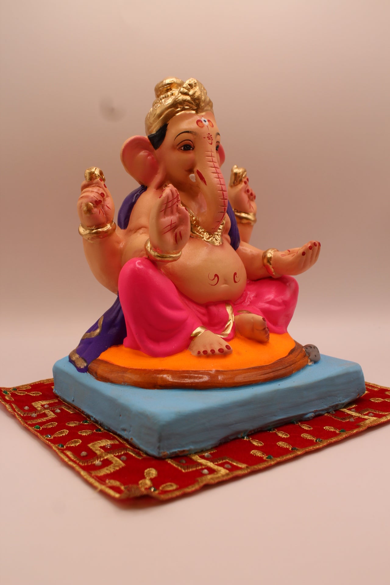 Eco-friendly 8 inch Ganesh Visarjan idol in purple shawl and rani pink dhoti – side view
