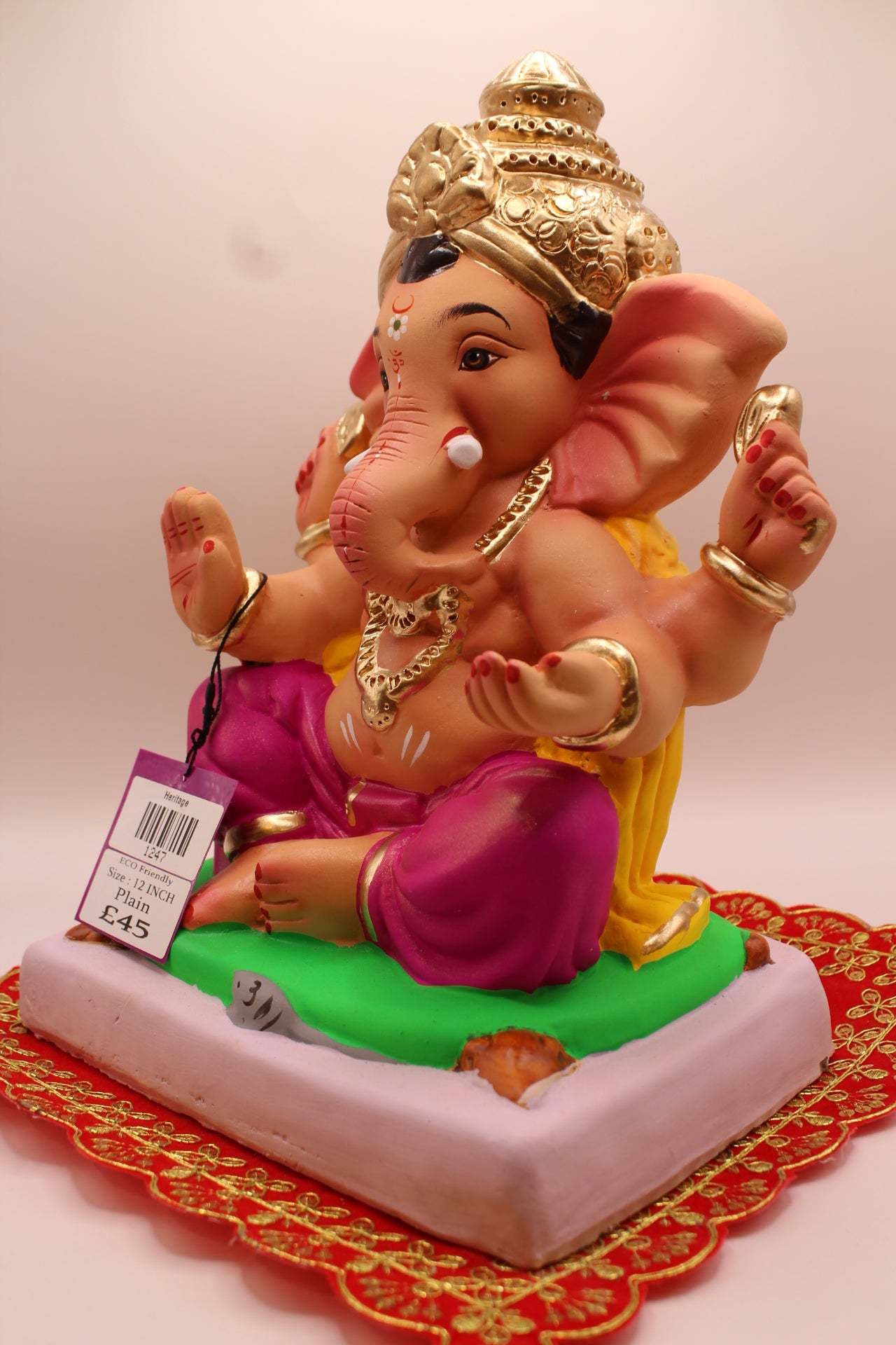 Eco-Friendly Ganesh Visarjan idol, Yellow Khes & Magenta Dhoti, Green Mat & Modaks, close-up