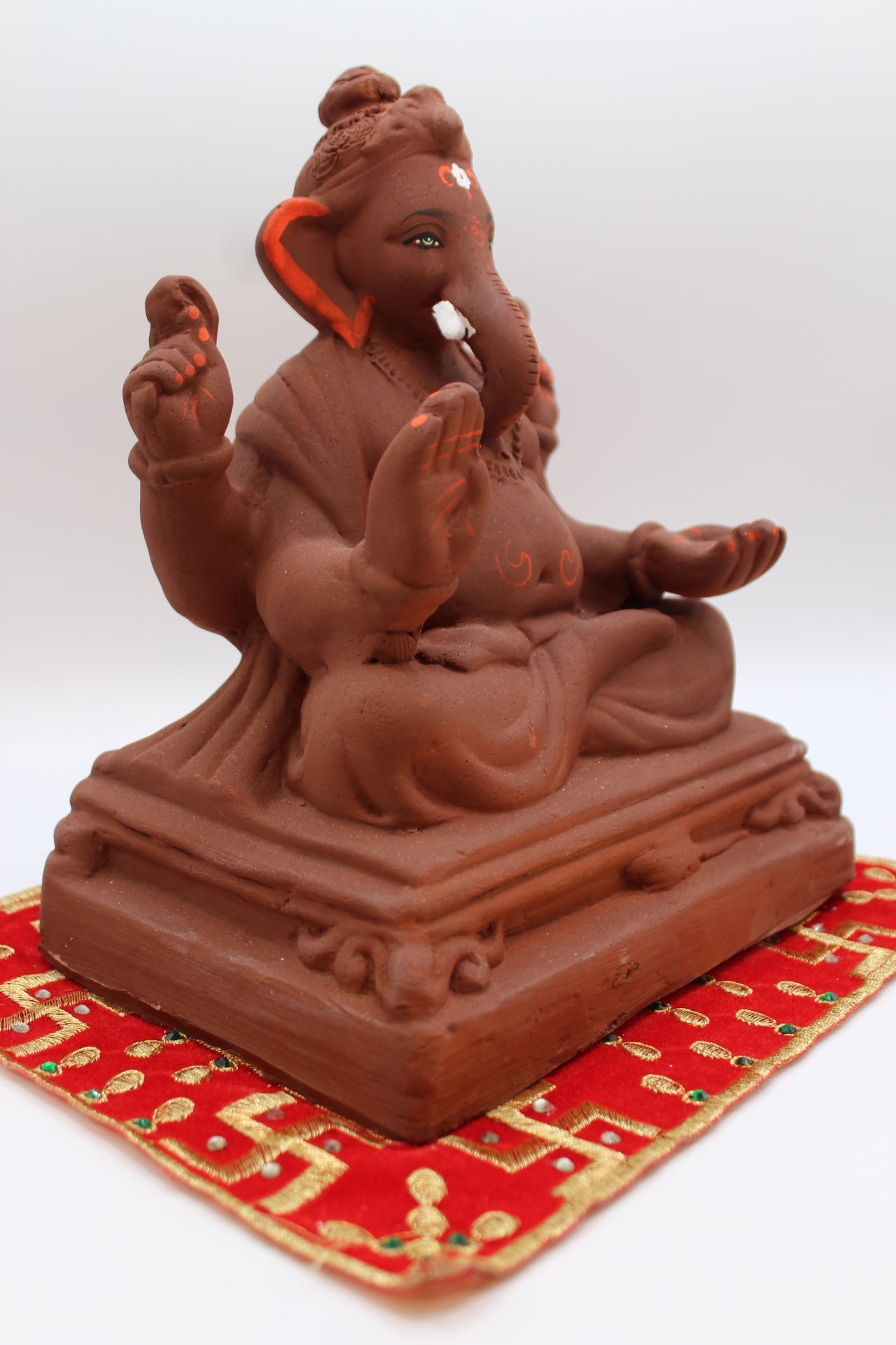 Natural terracotta eco-friendly 8 inch Ganesh Visarjan idol on pedestal base – side view