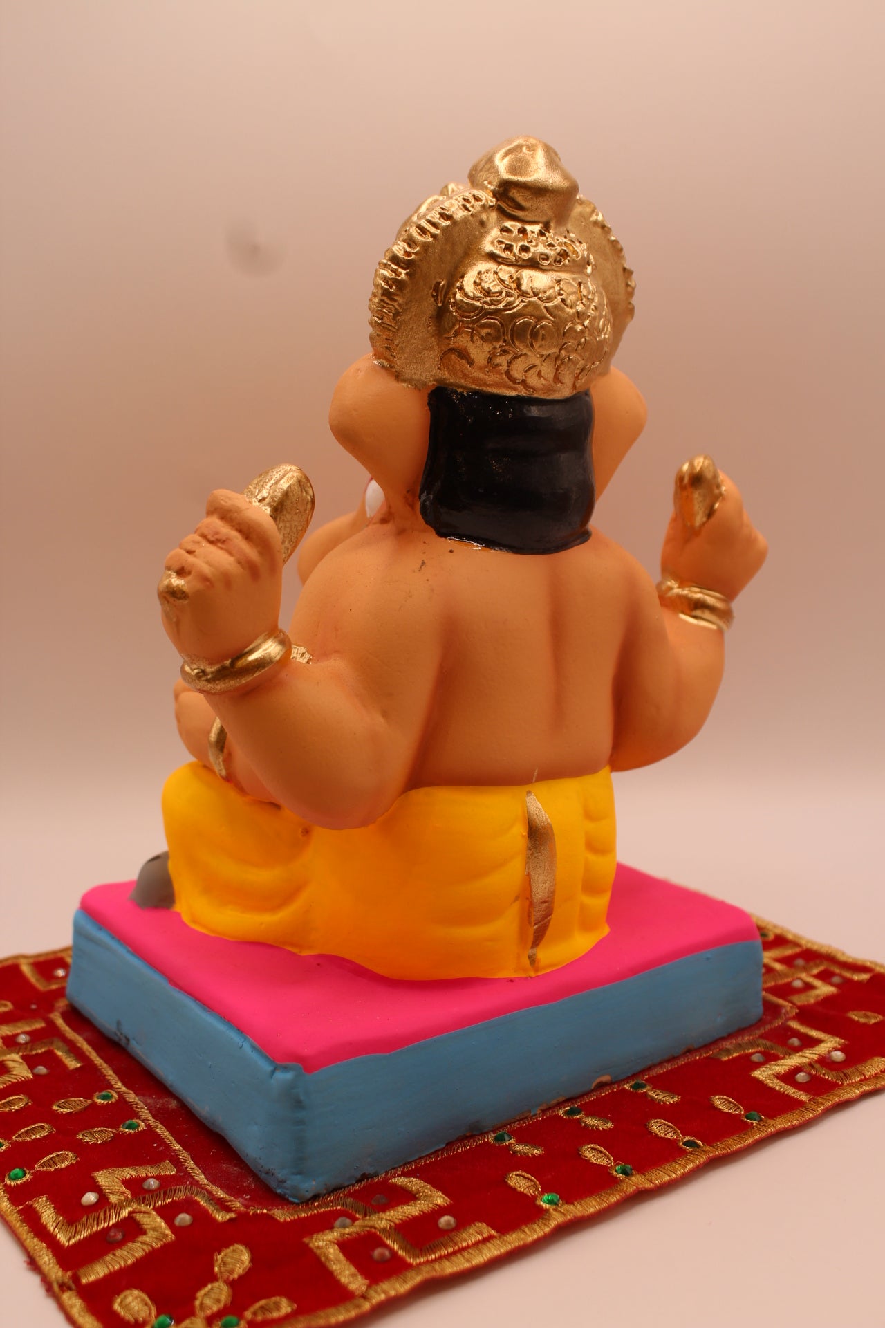 Eco-friendly 8 inch Ganesh Visarjan idol with yellow dhoti and gold fan crown – back view