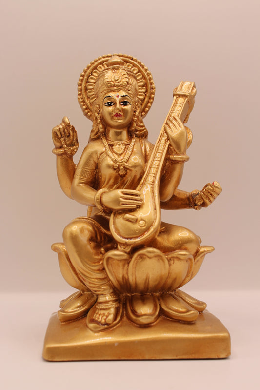 Gold Saraswati resin statue with veena, front