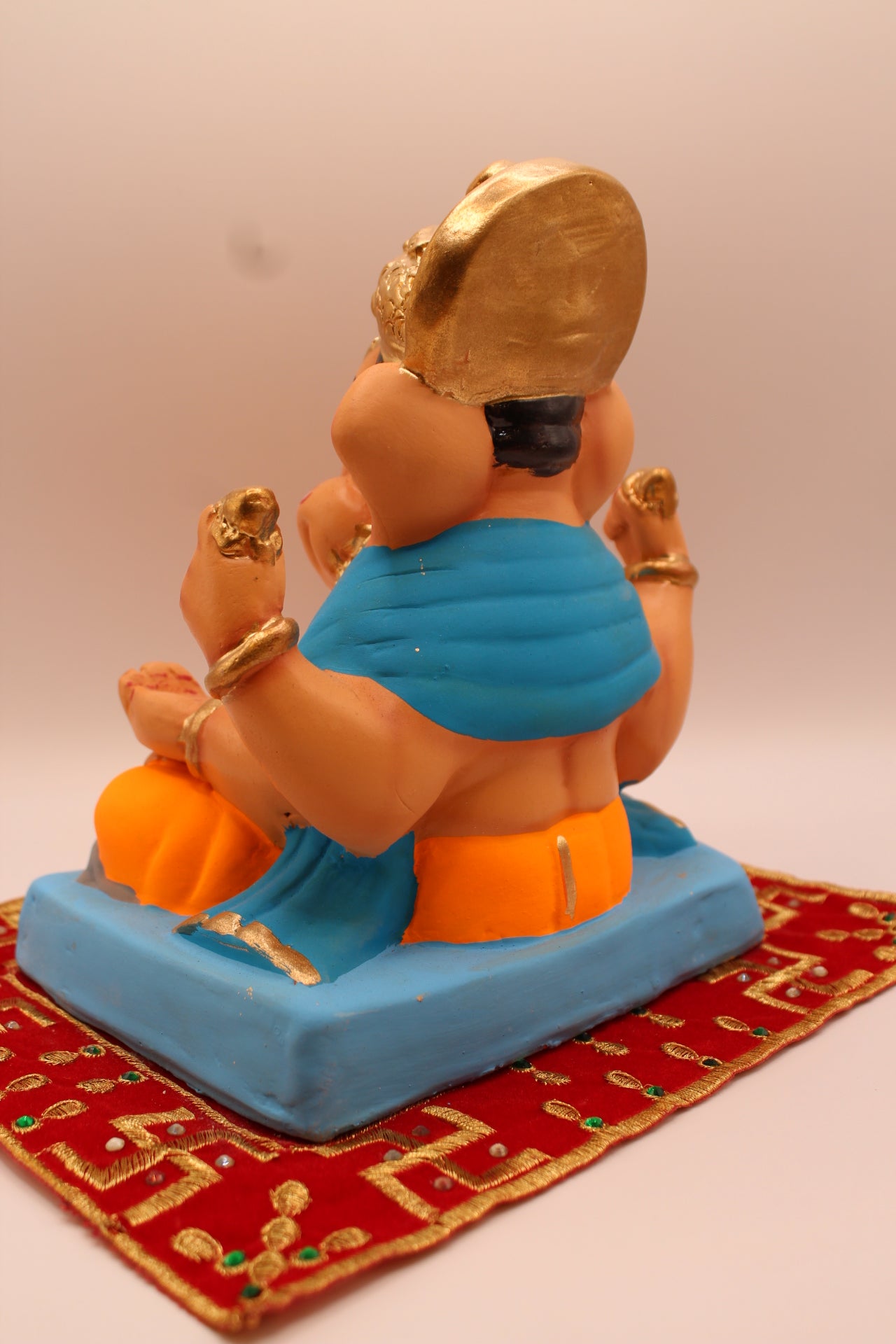 Eco-friendly 8 inch Ganesh Visarjan idol in sky blue shawl and orange dhoti – back view