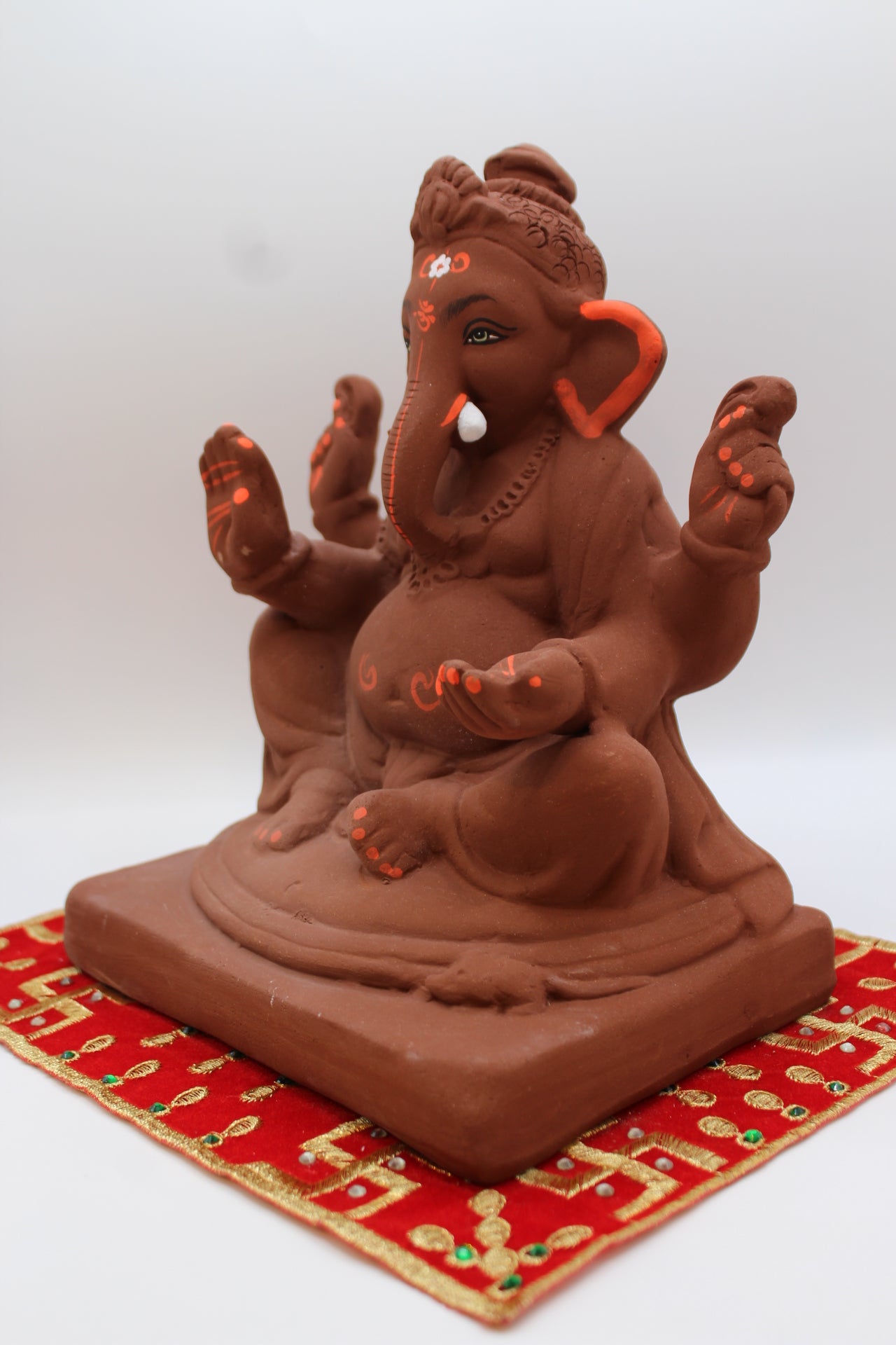 Natural terracotta eco-friendly 8 inch Ganesh Visarjan idol with bun topknot – detail view
