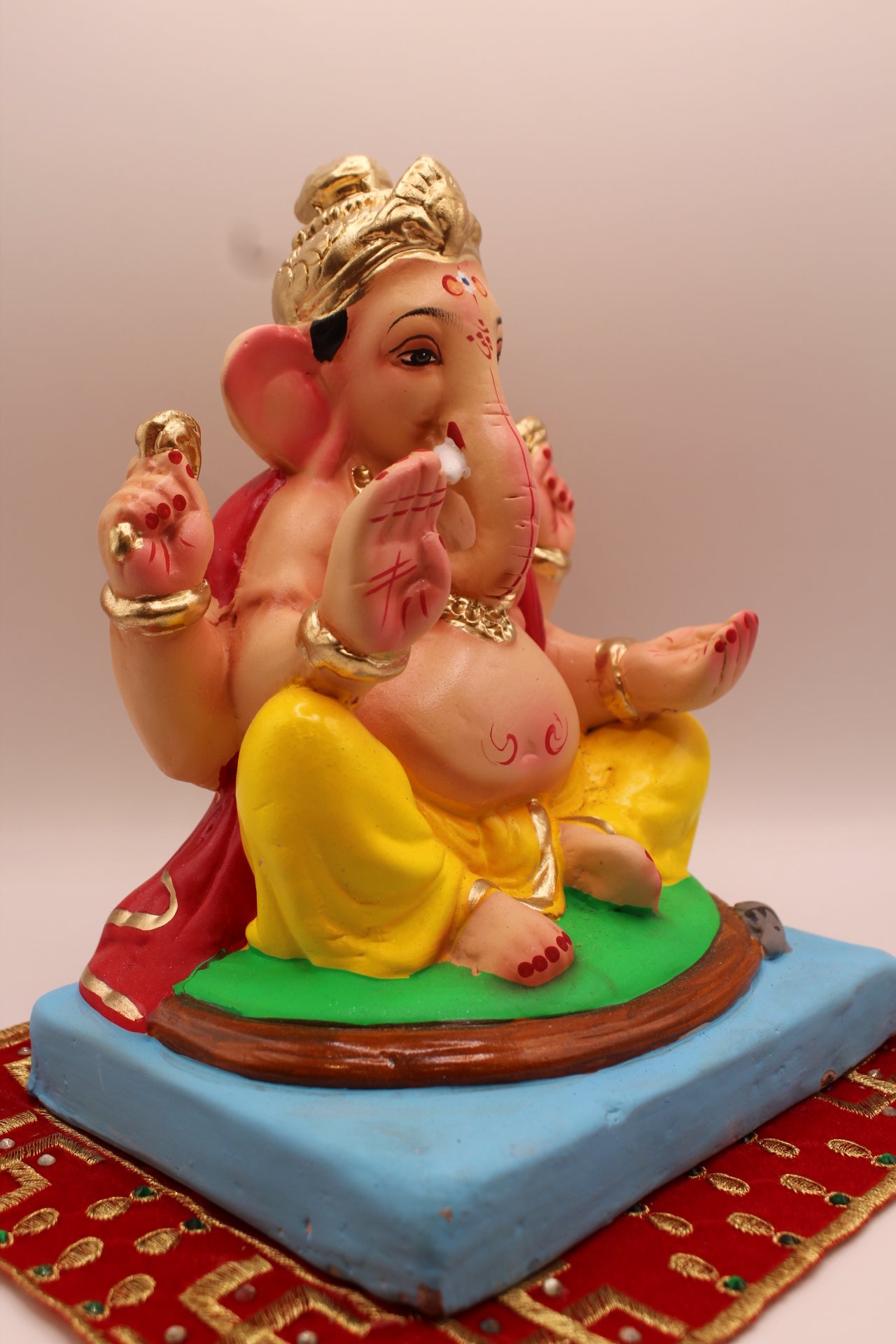 Eco-friendly 8 inch Ganesh Visarjan idol in red khes and yellow dhoti – side view