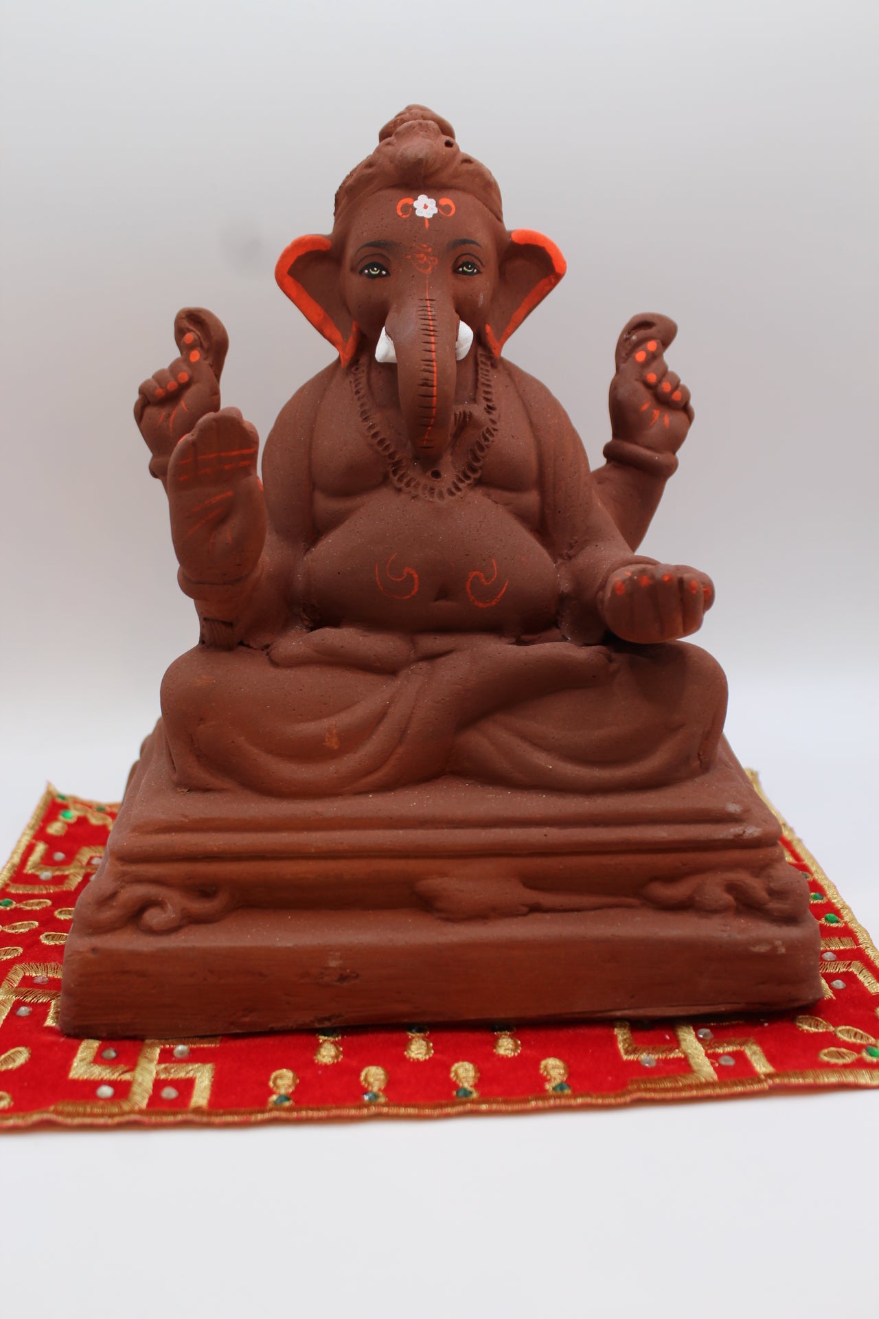Natural terracotta eco-friendly 8 inch Ganesh Visarjan idol on pedestal base – front view
