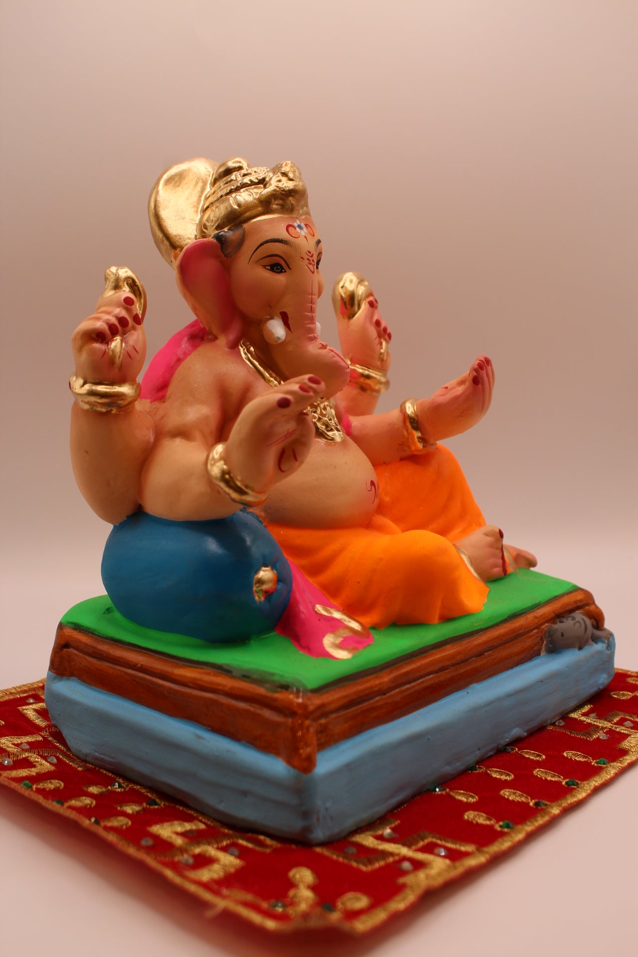 Eco-friendly 8 inch Ganesh Visarjan idol in pink khes and orange dhoti – side view
