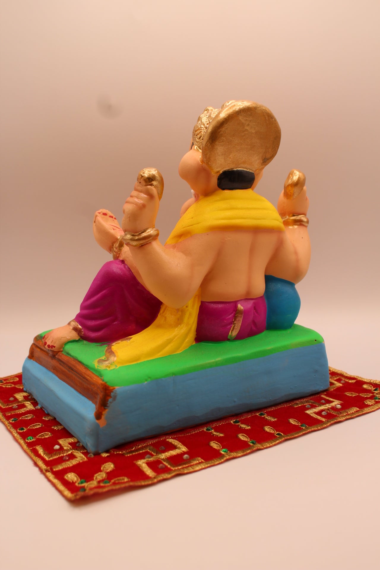 Eco-friendly 8 inch Ganesh Visarjan idol in yellow shawl and magenta dhoti – back view