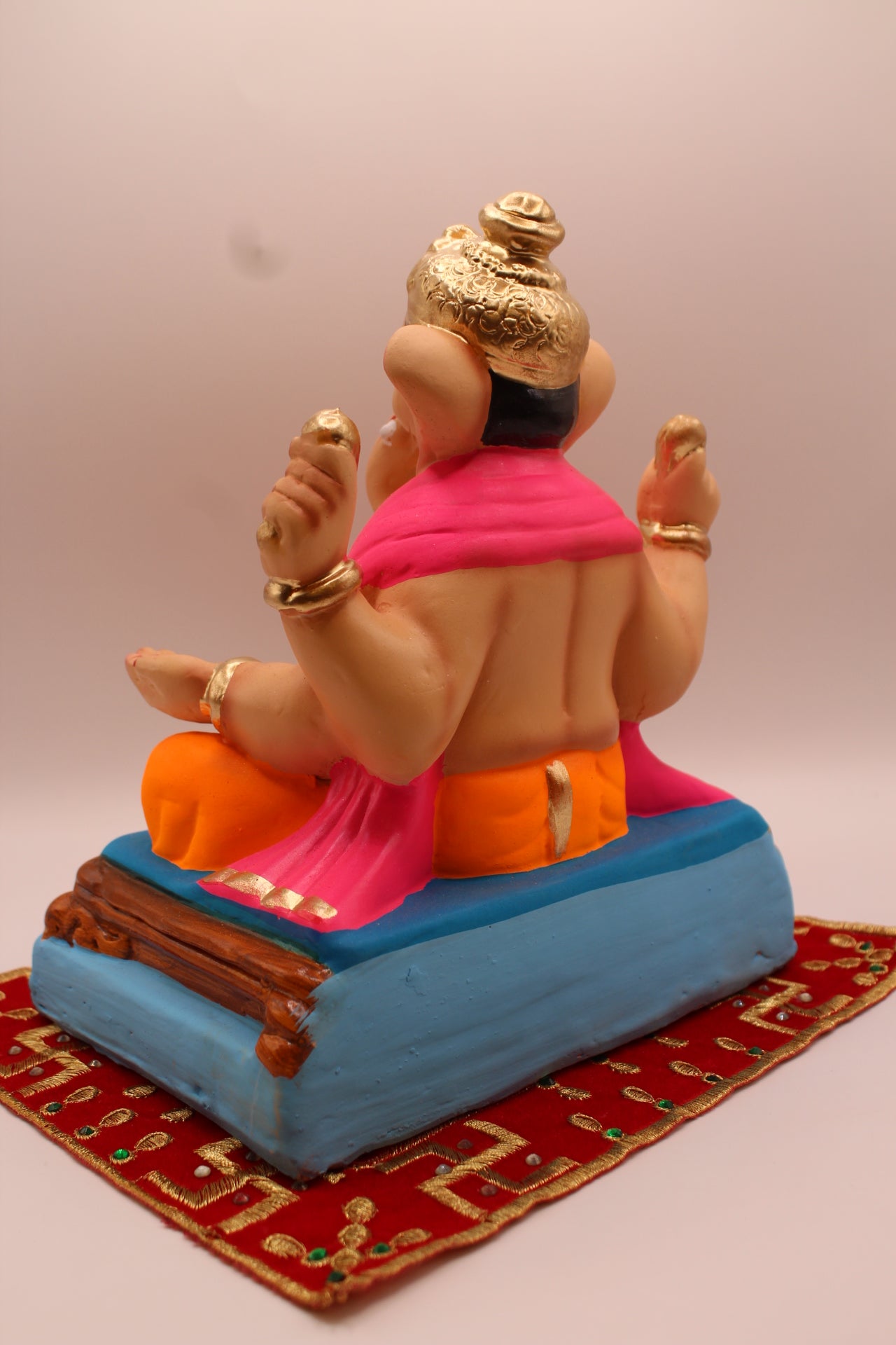Eco-friendly 8 inch Ganesh Visarjan idol in pink shawl and orange dhoti – back view