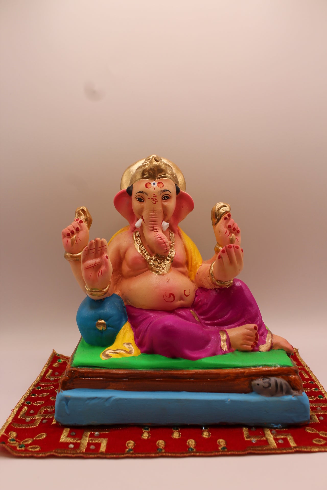 Eco-friendly 8 inch Ganesh Visarjan idol in yellow shawl and magenta dhoti, relaxed pose – front view