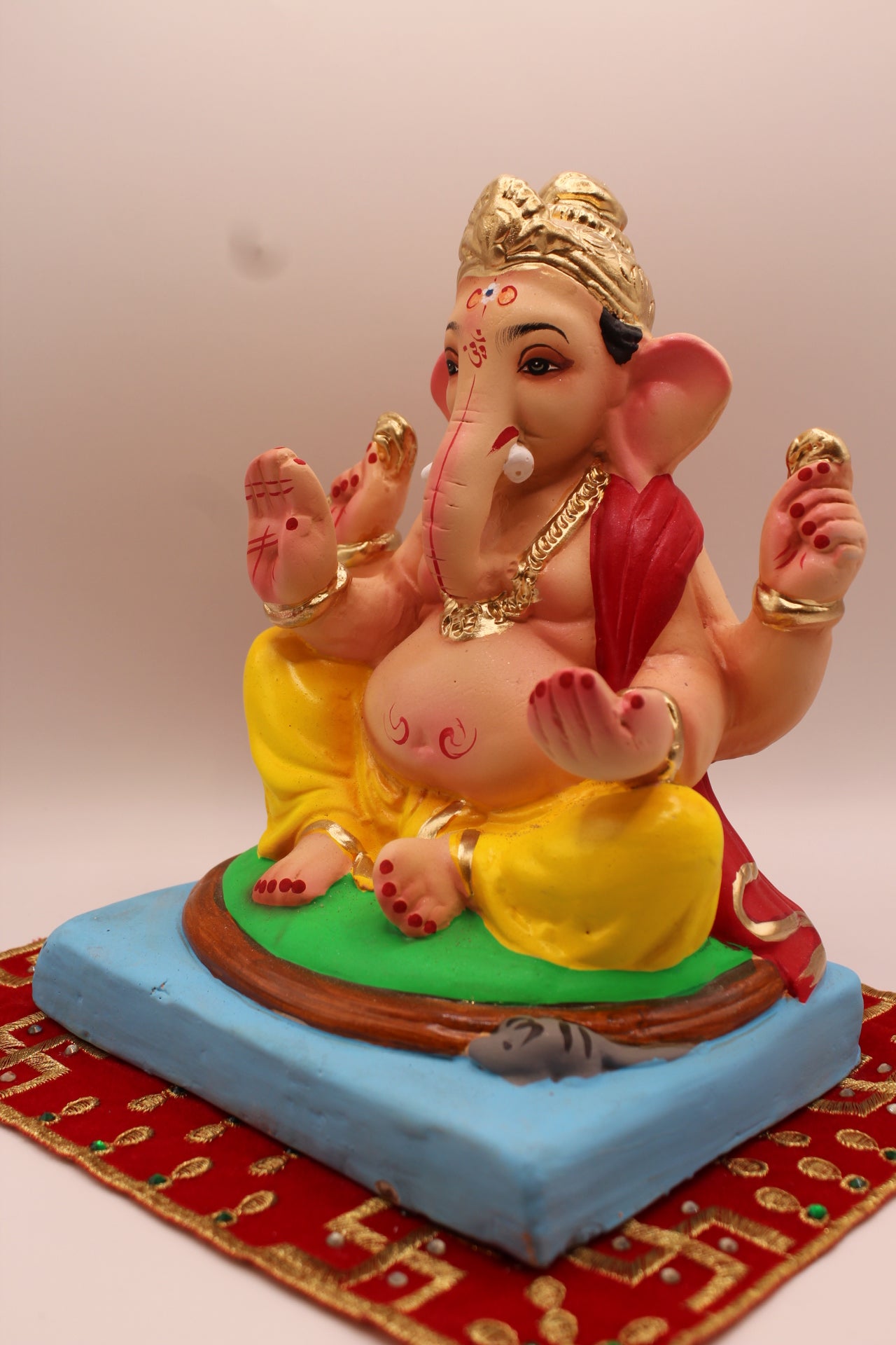 Eco-friendly 8 inch Ganesh Visarjan idol in red khes and yellow dhoti – detail view