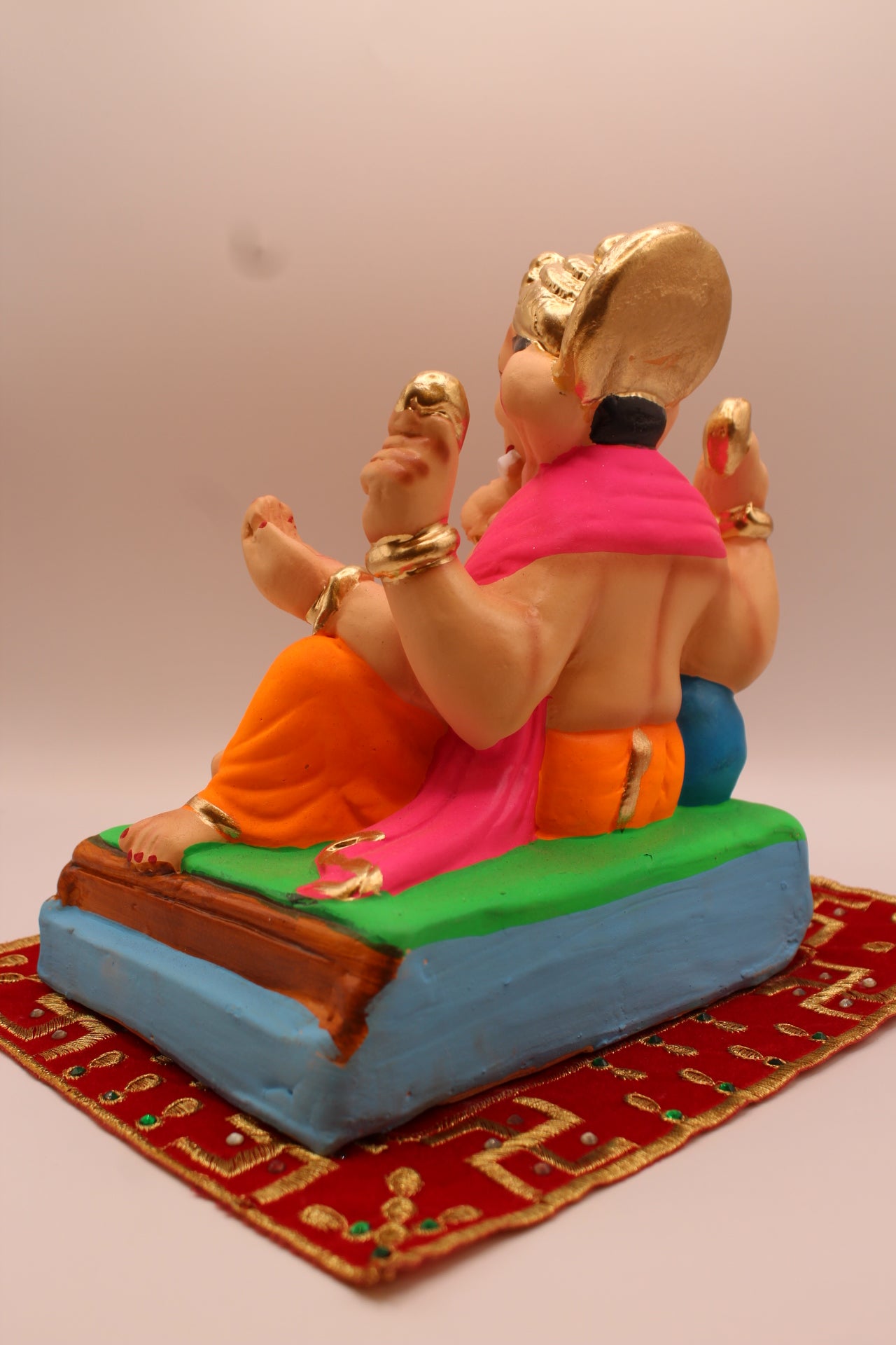 Eco-friendly 8 inch Ganesh Visarjan idol in pink khes and orange dhoti – back view