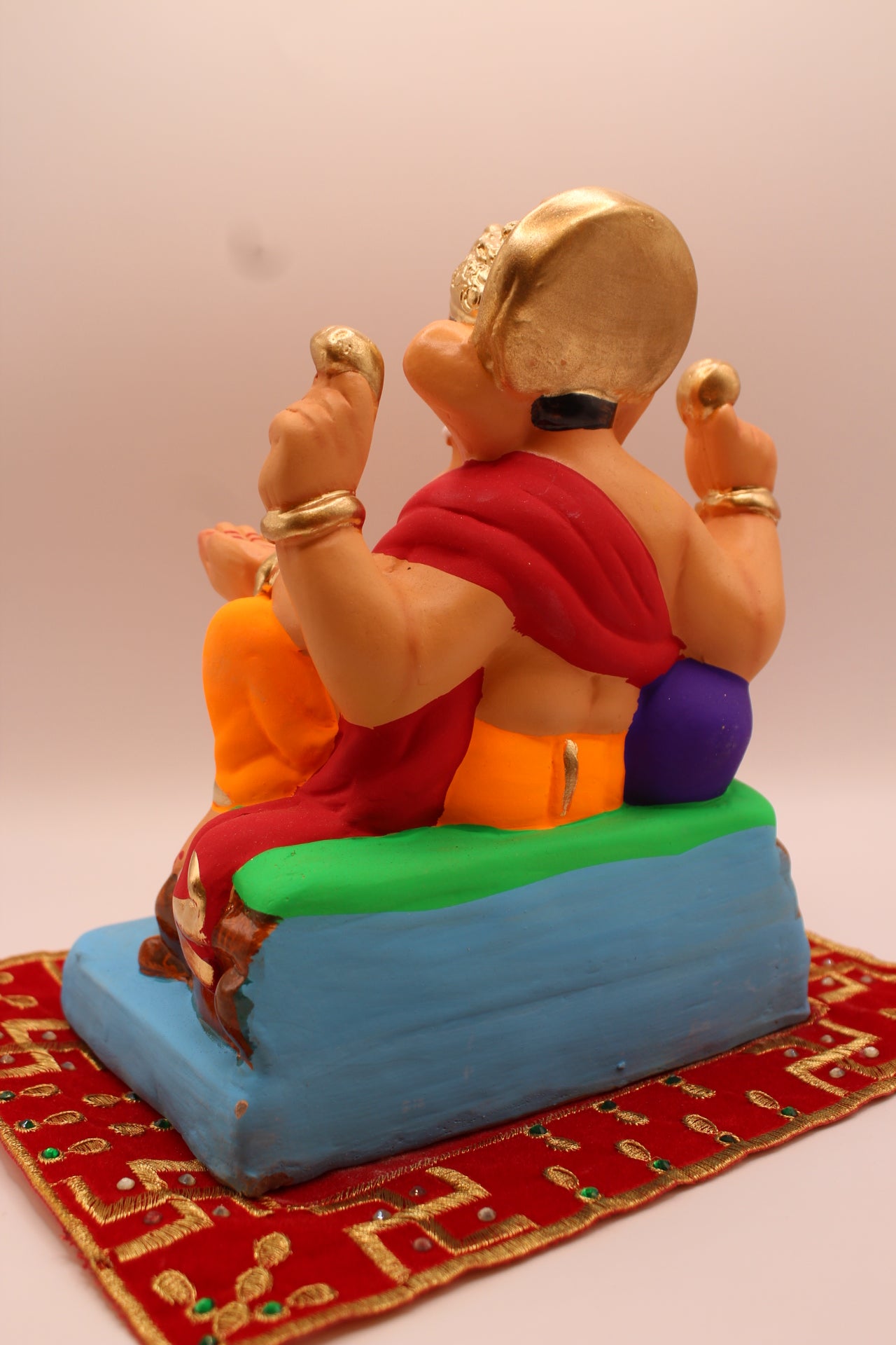 Eco-friendly 8 inch Ganesh Visarjan idol in maroon shawl and orange dhoti – back view
