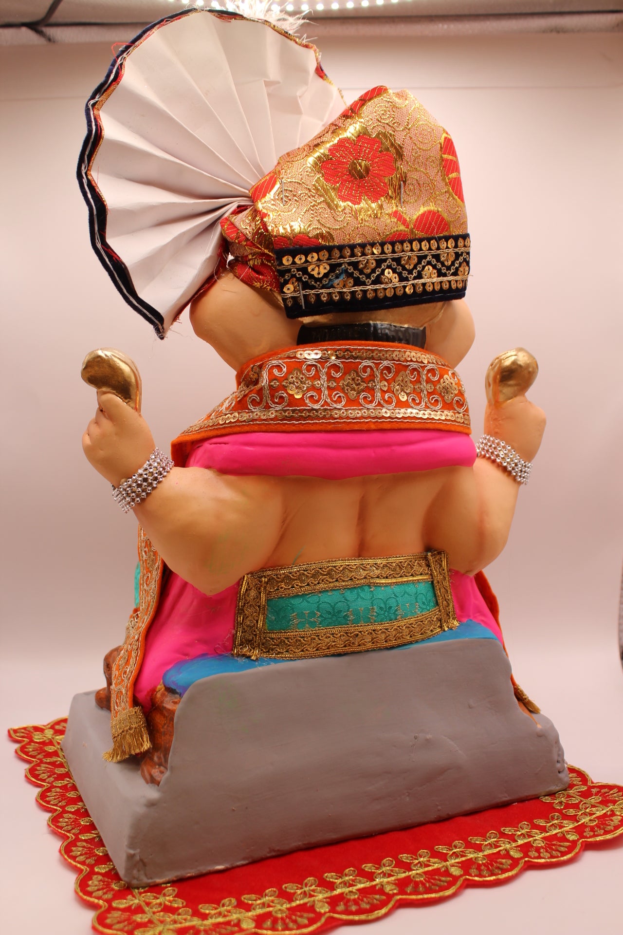 Back view – sea green dhoti with red brocade safa and black-gold fan