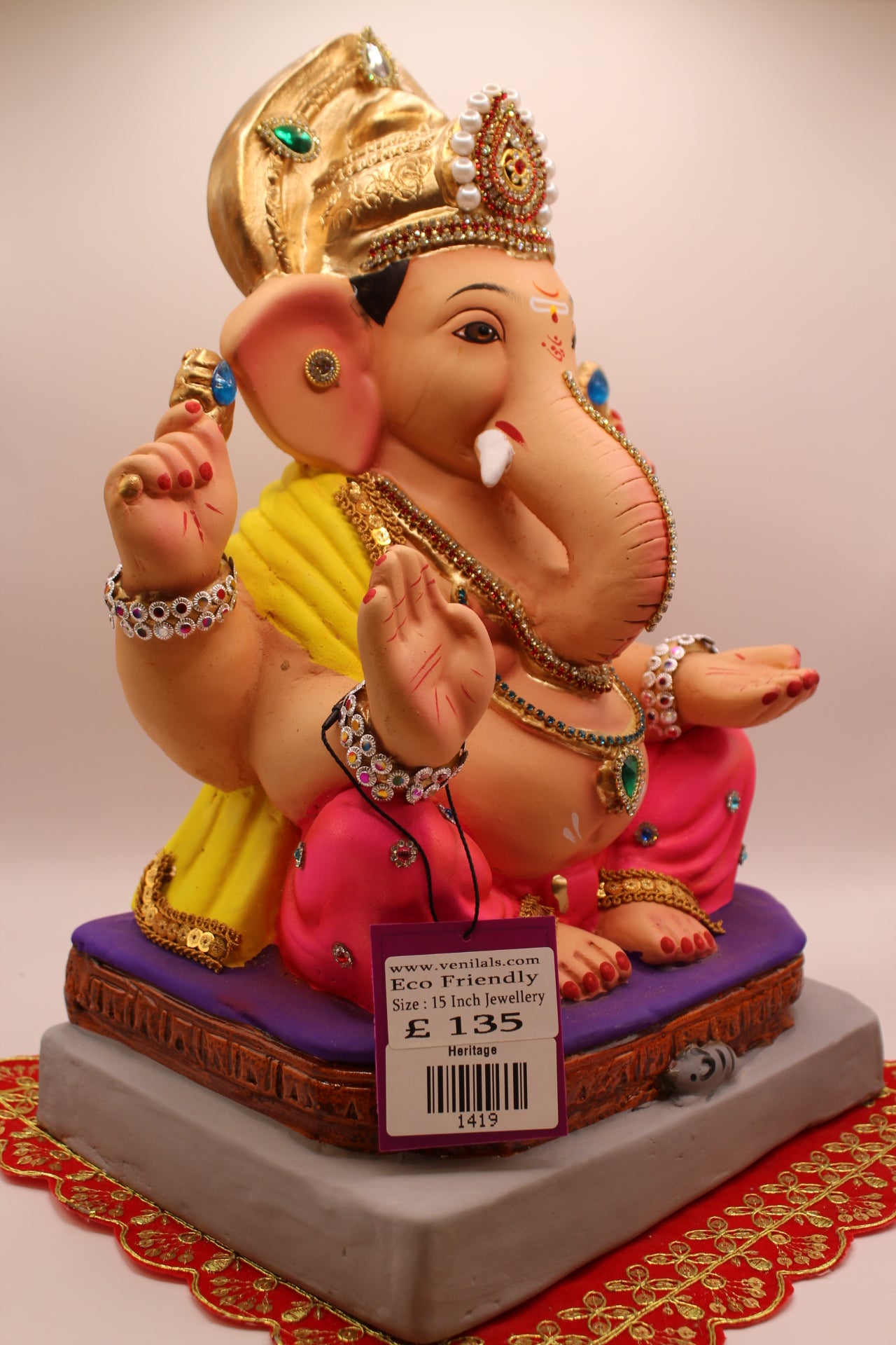 Side view – jewellery style idol with gold leaf mukut and yellow khes