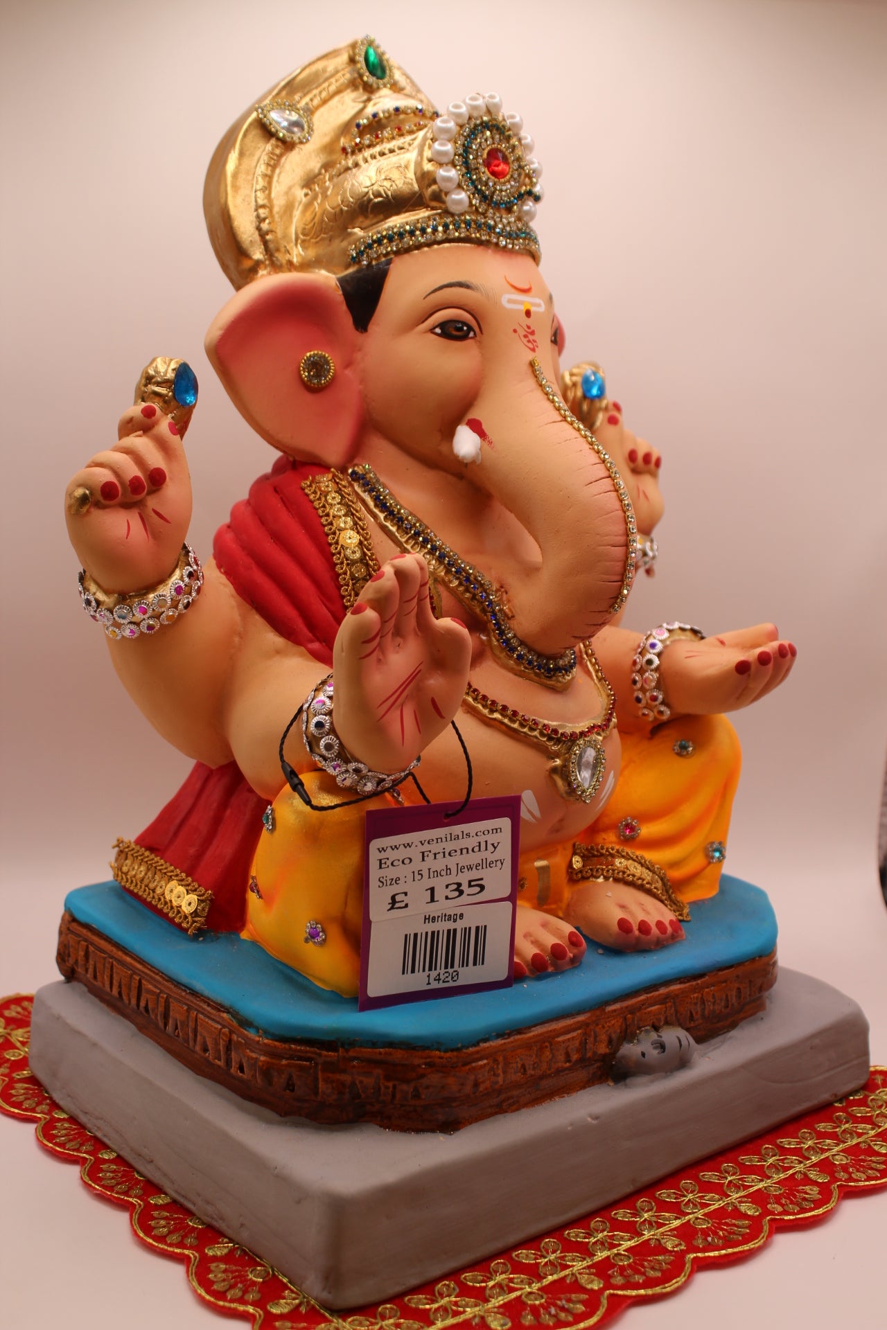 Side view – jewellery style idol with red khes and orange dhoti