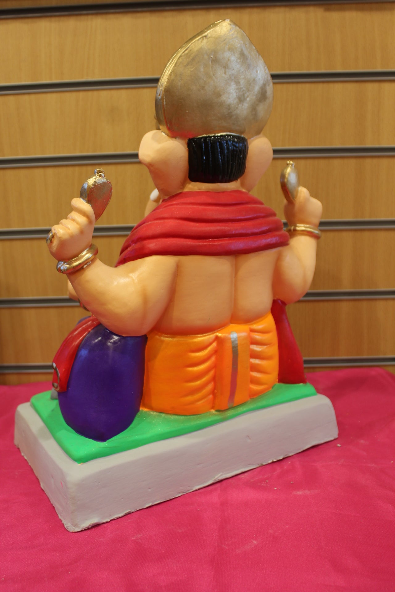 Back view – red khes and orange dhoti with purple bolster