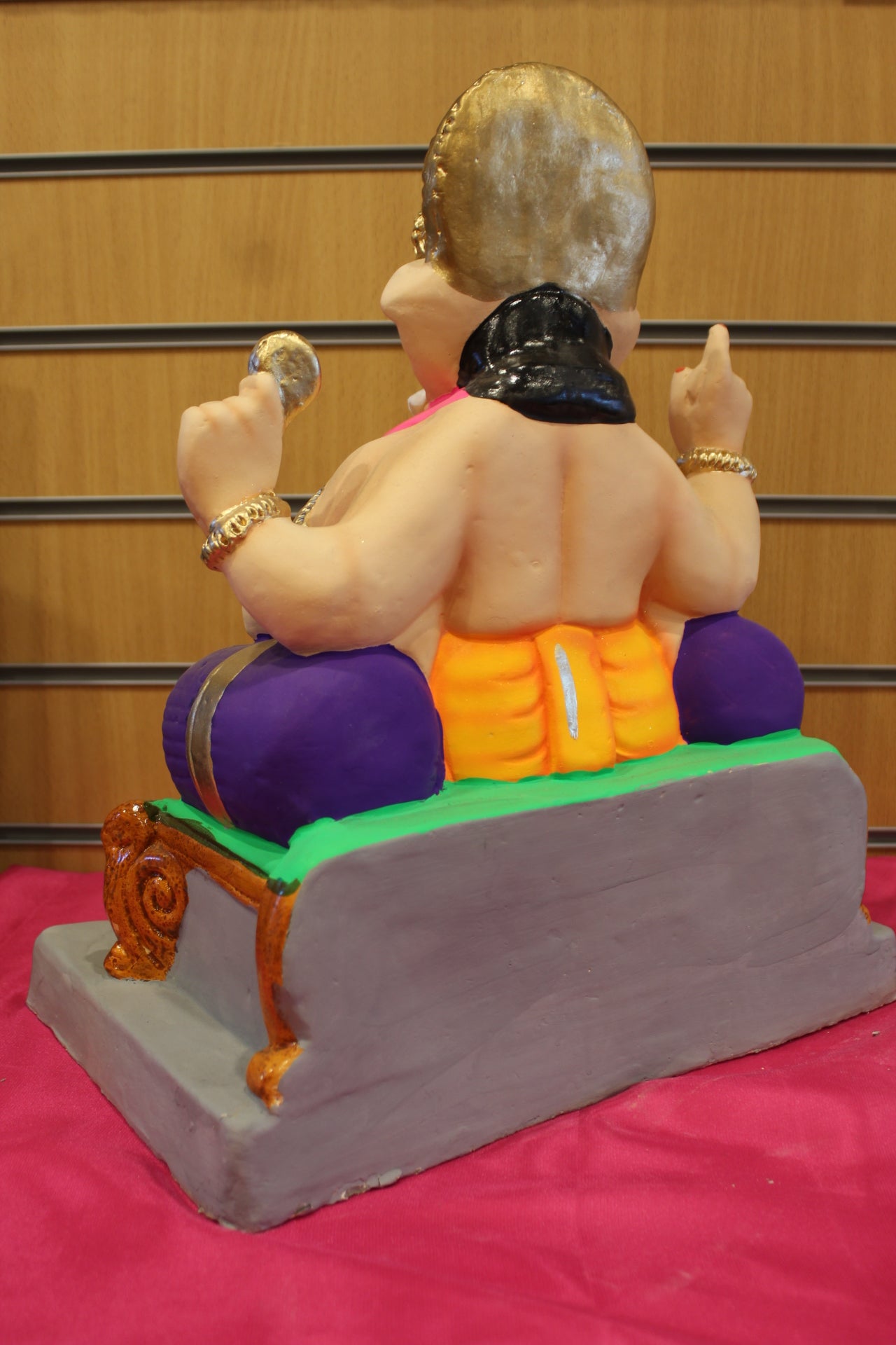 Back view – pink khes and orange dhoti with purple bolster