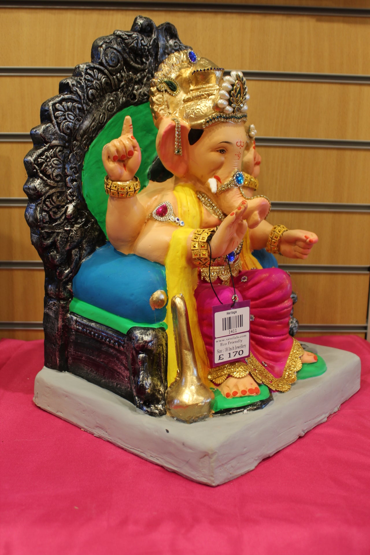 Side view – jewellery style idol on carved silver throne