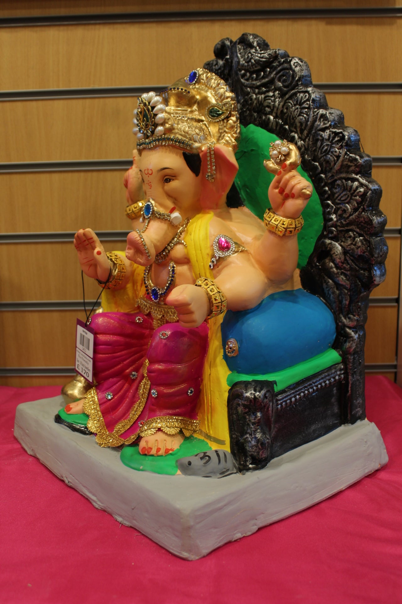 Angled view – jewellery style idol on carved silver throne