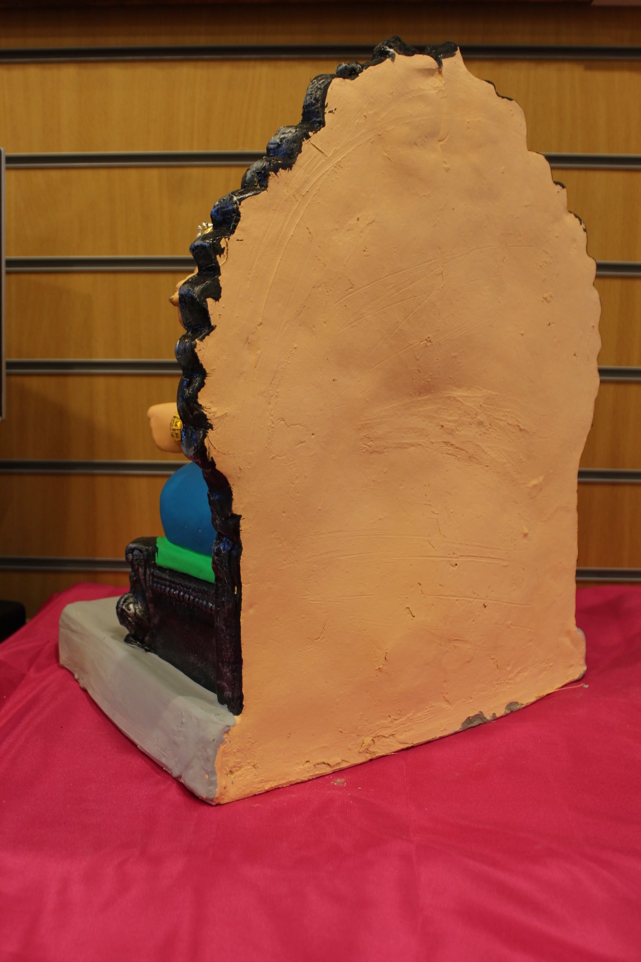 Back view – jewellery style idol on carved silver throne