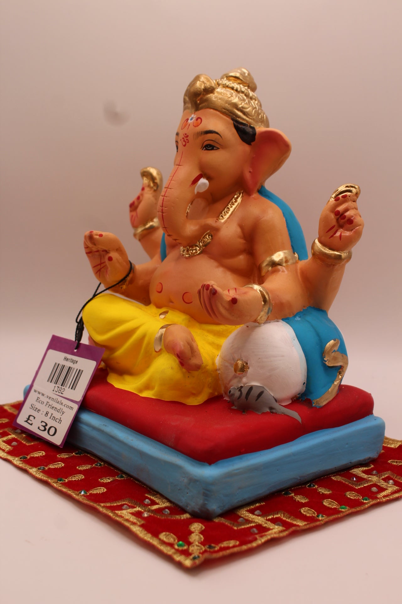 Angled view – teal khes and yellow dhoti on a red cushion