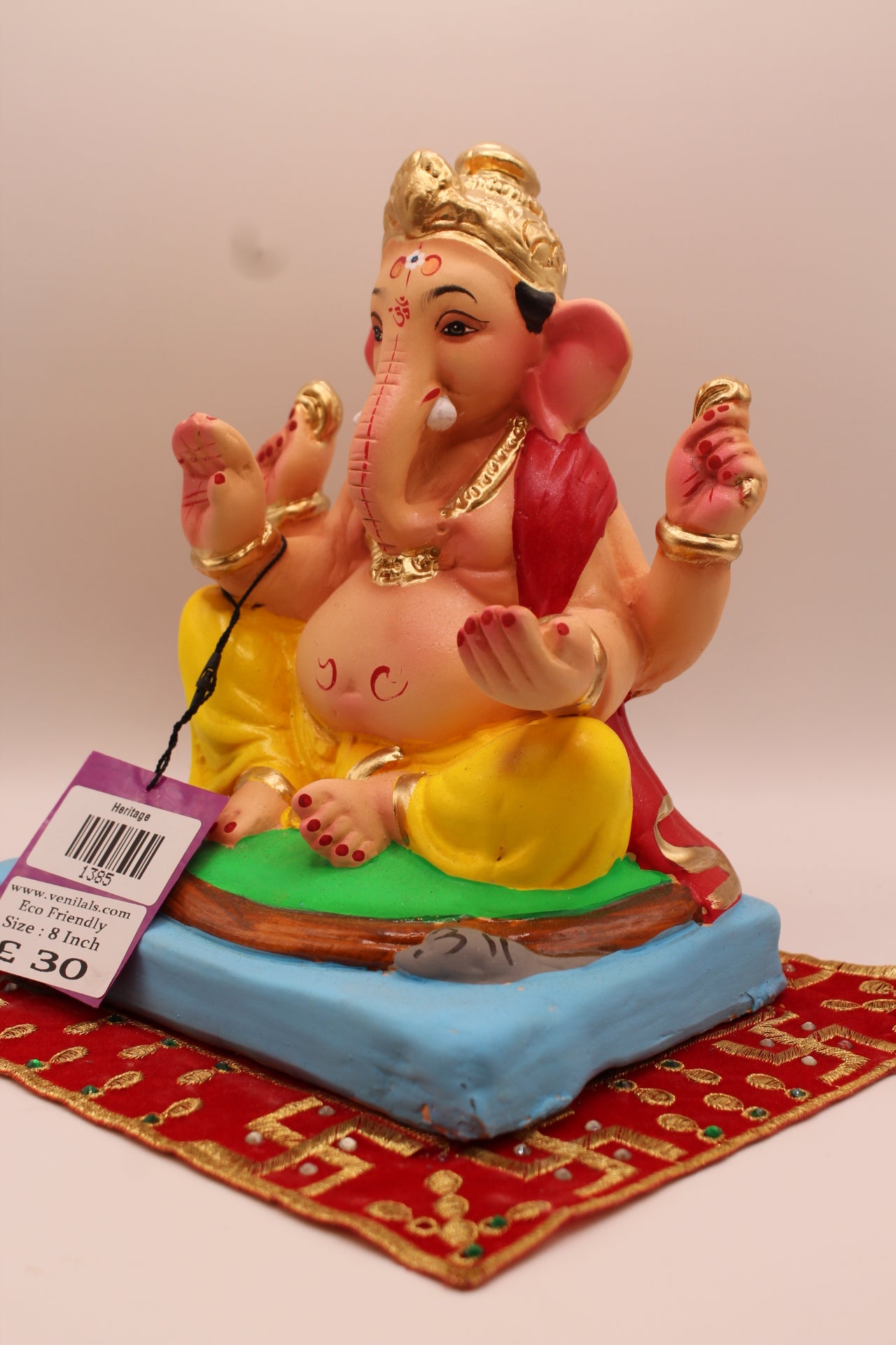 Angled view – red khes trailing down the back over a yellow dhoti