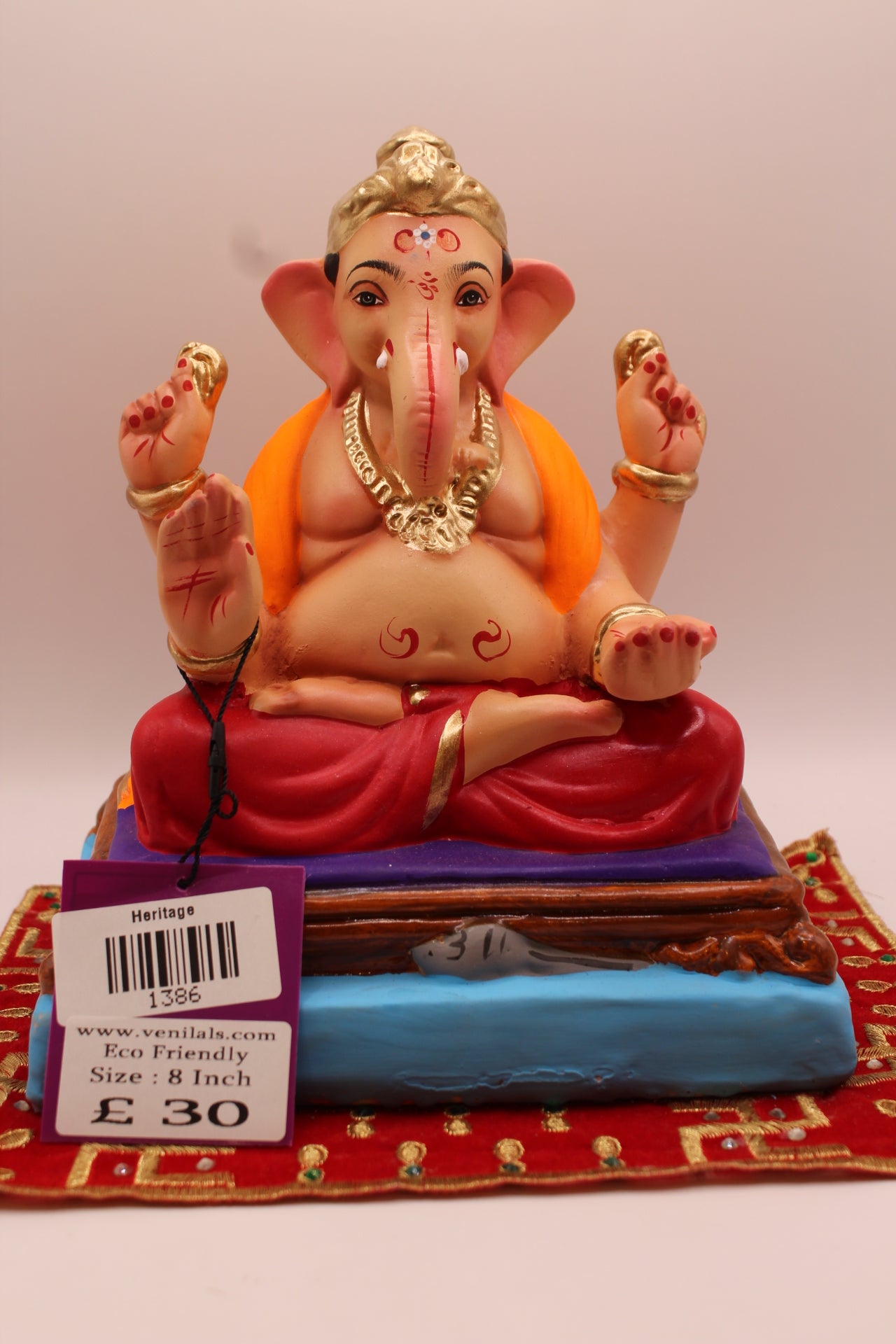 8 inch eco-friendly Ganesh idol – orange khes and maroon dhoti on a purple mat, front