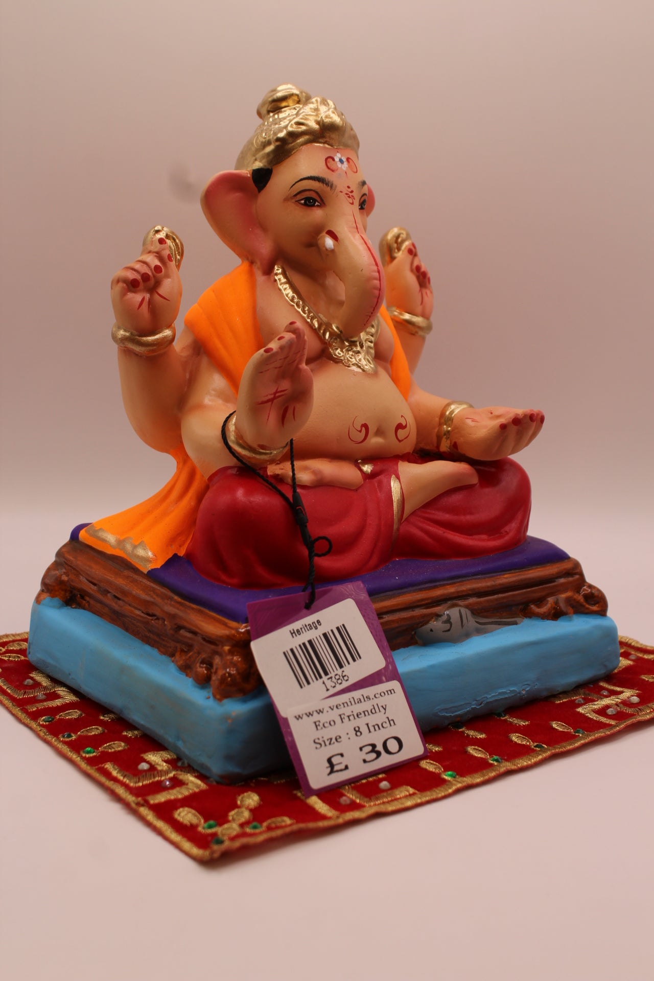 Side view – orange khes and maroon dhoti on a purple mat