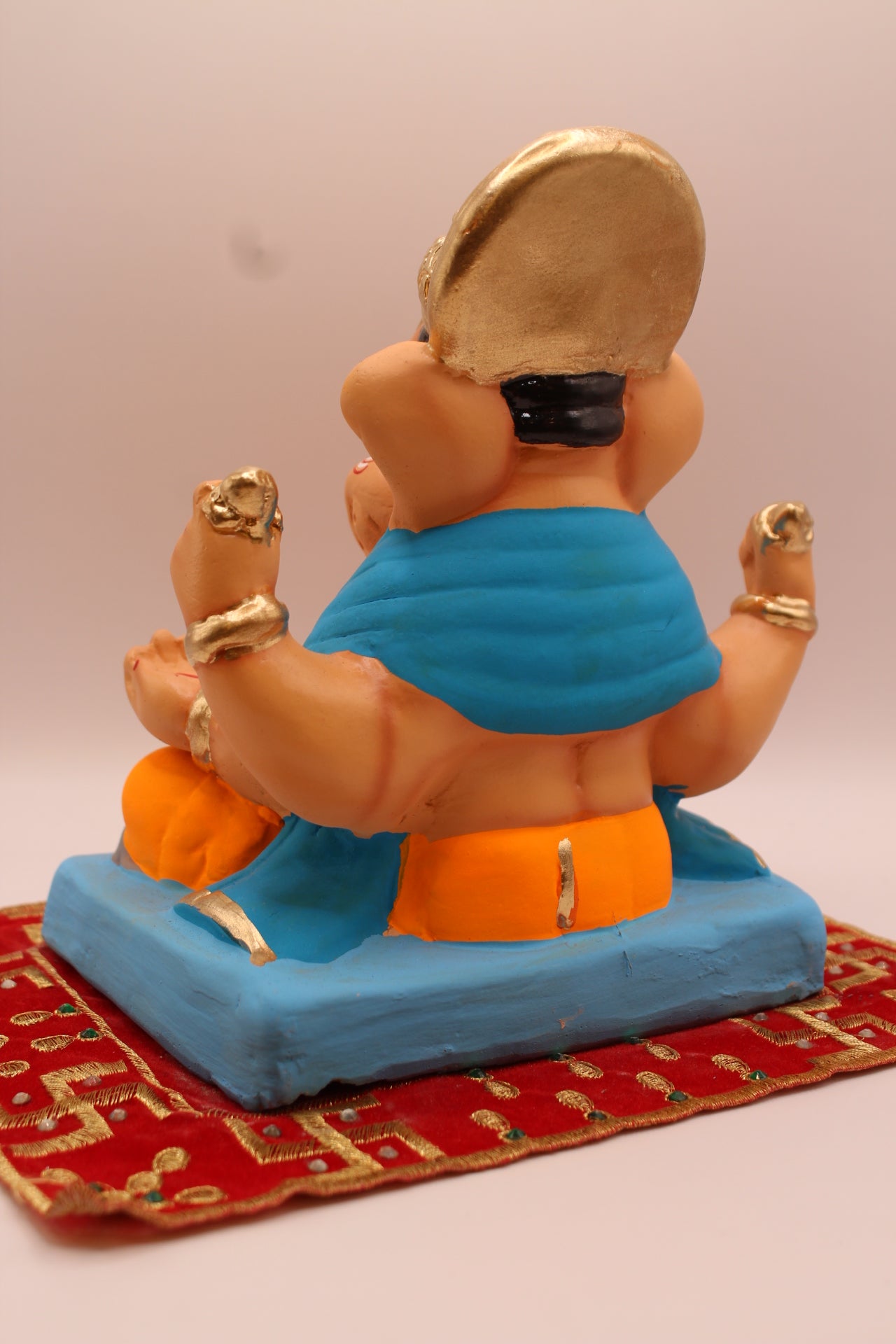 Back view – sky blue khes and orange dhoti with halo crown