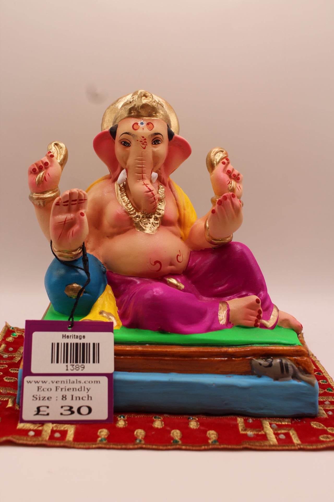 8 inch eco-friendly Ganesh idol – yellow khes and magenta dhoti leaning on a blue cushion, front