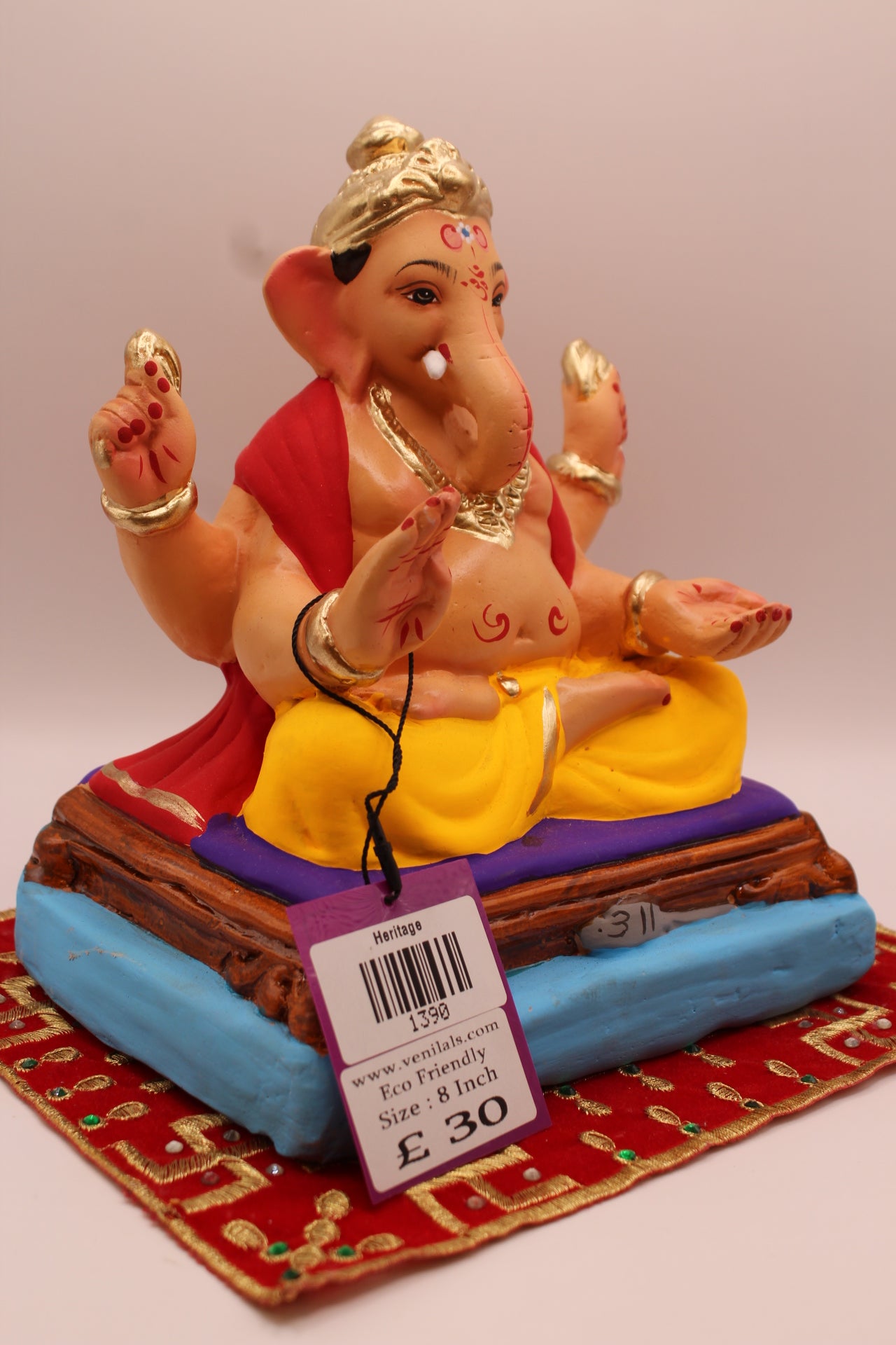 Side view – red khes over both shoulders with crested gold mukut