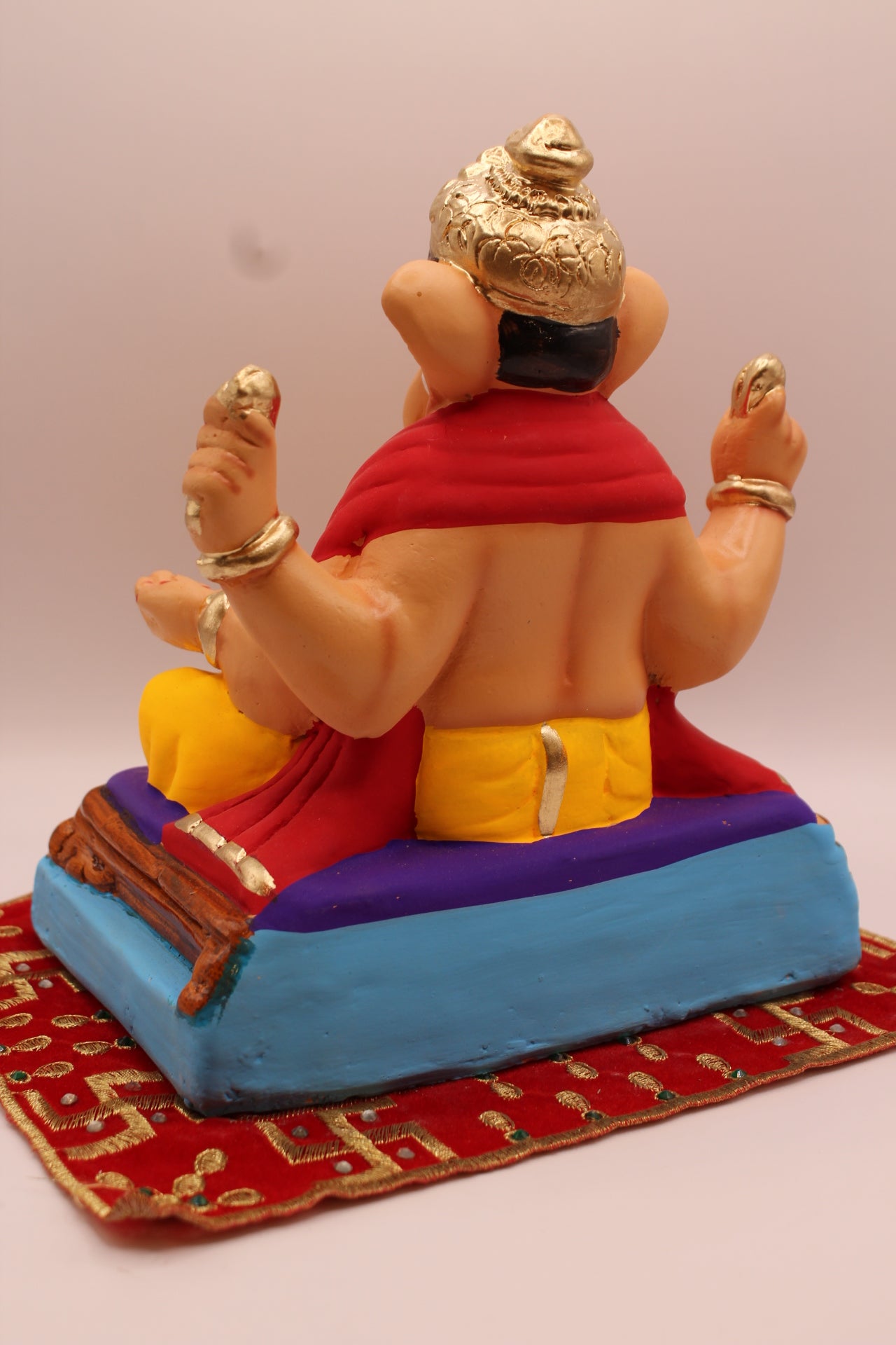 Back view – red khes over both shoulders with crested gold mukut