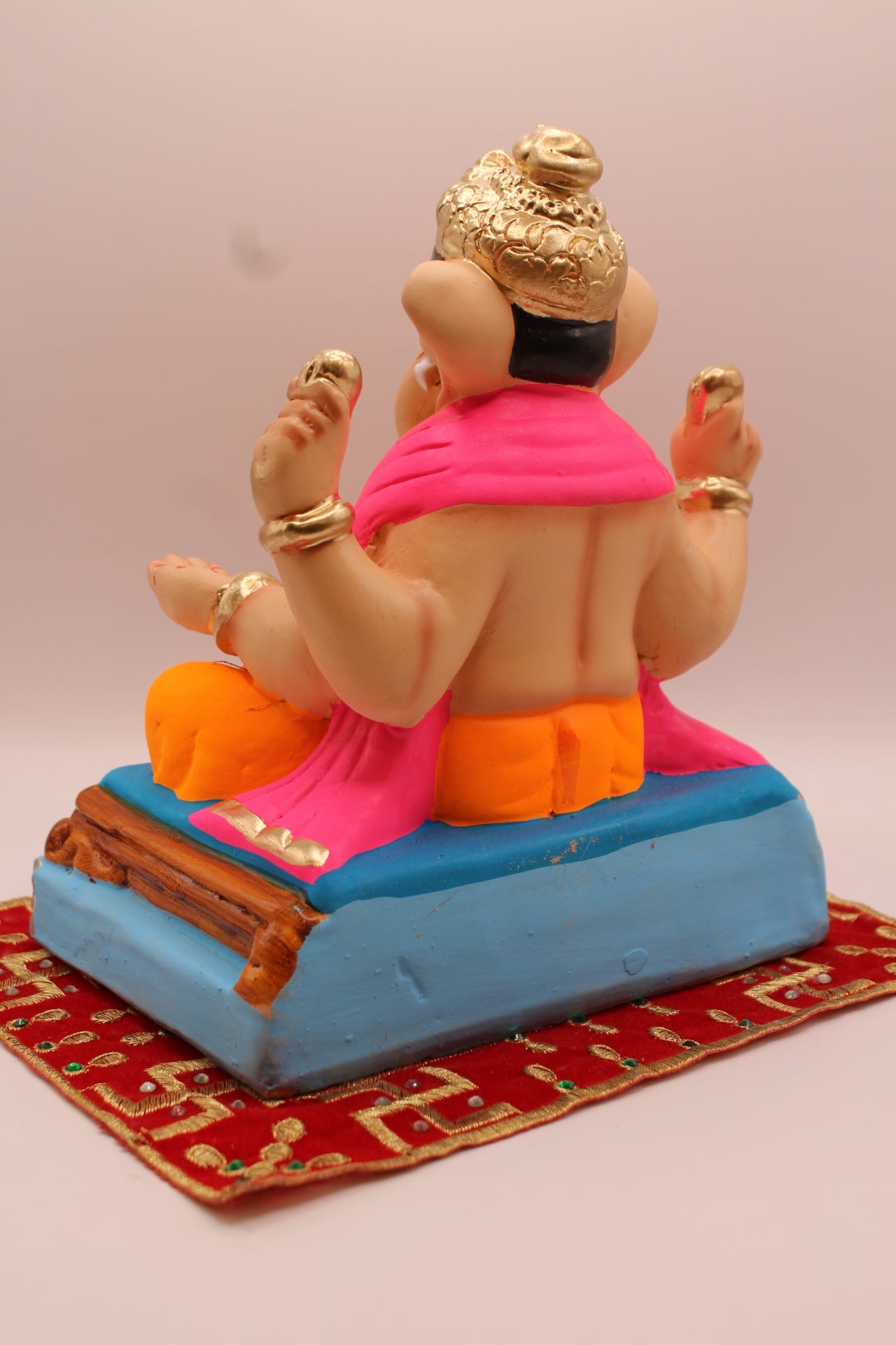 Back view – rani pink khes and orange dhoti on a purple mat