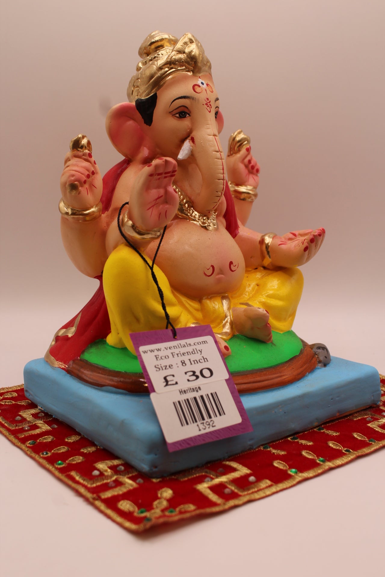 Side view – red khes and yellow dhoti with fluted gold crown
