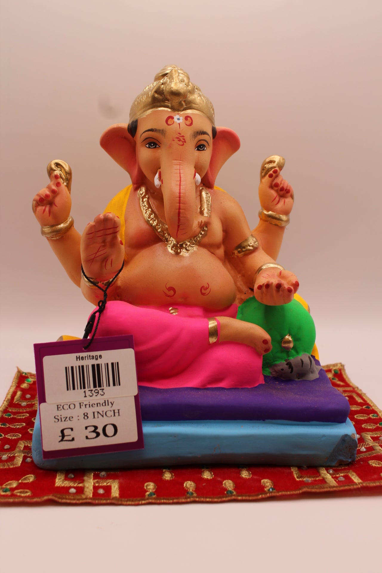 8 inch eco-friendly Ganesh idol – yellow khes and pink dhoti reclining on a purple mat, front