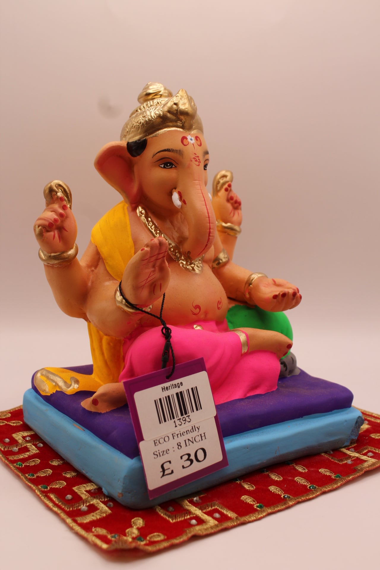 Side view – yellow khes and pink dhoti reclining on a purple mat